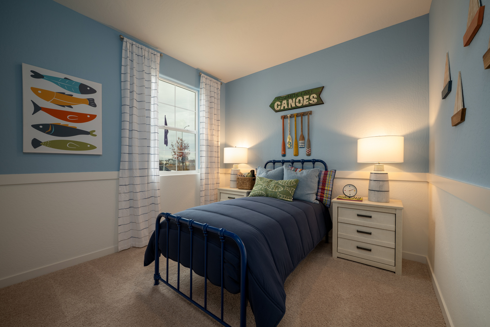 A bedroom with a bed and a lamp.