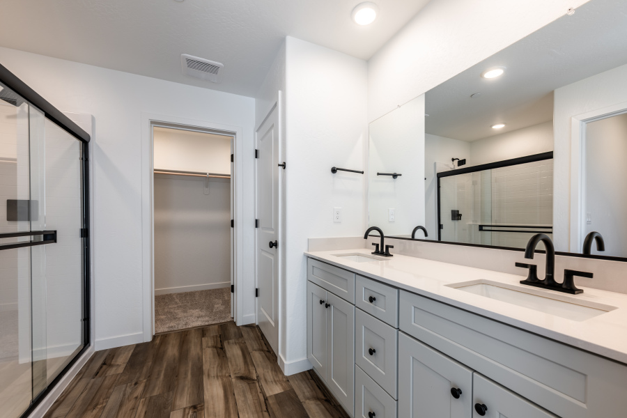 A bathroom with white cabinets.