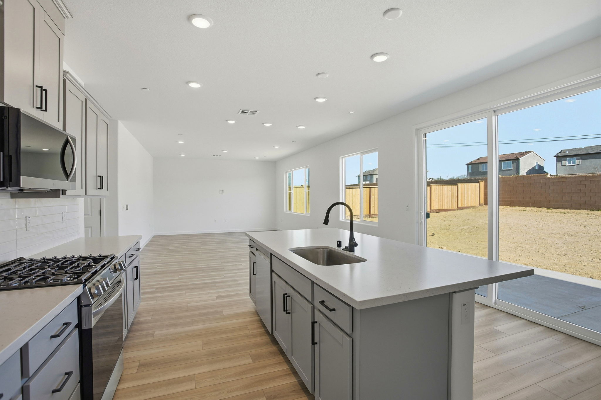A kitchen with a large window.