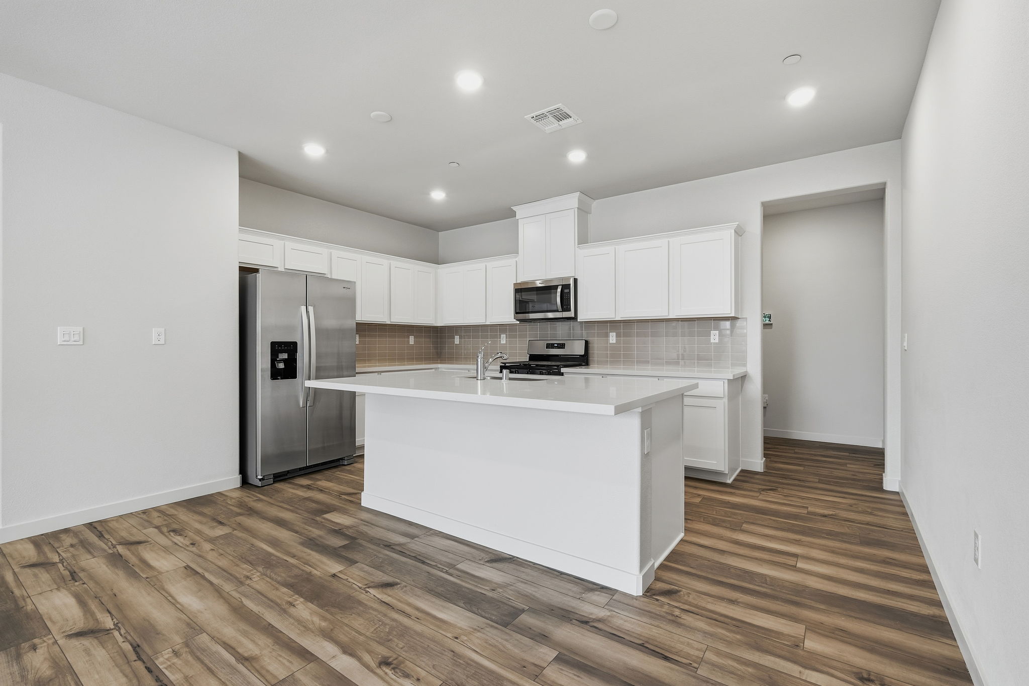 A kitchen with white cabinets.