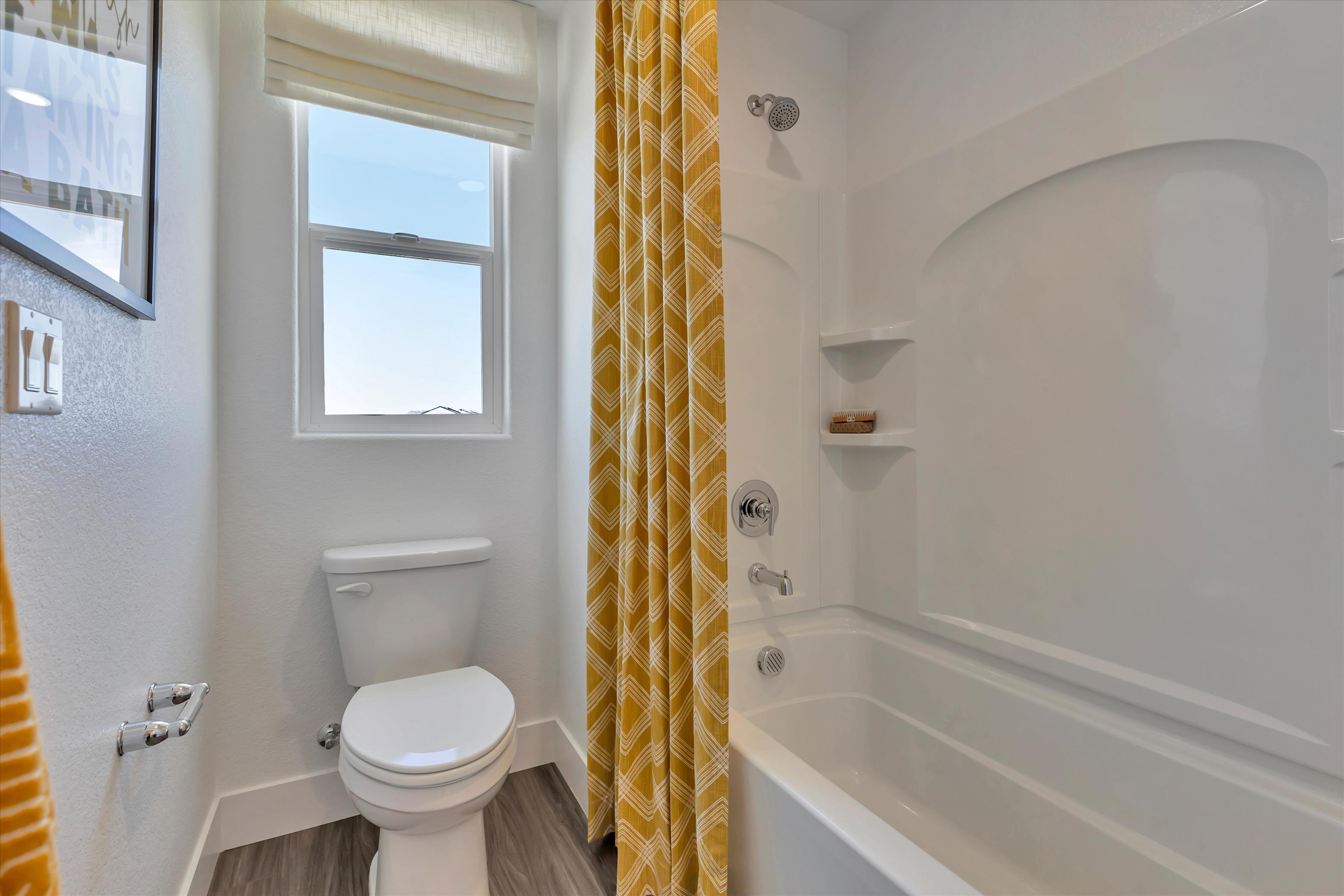 A bathroom with a tub toilet and sink.