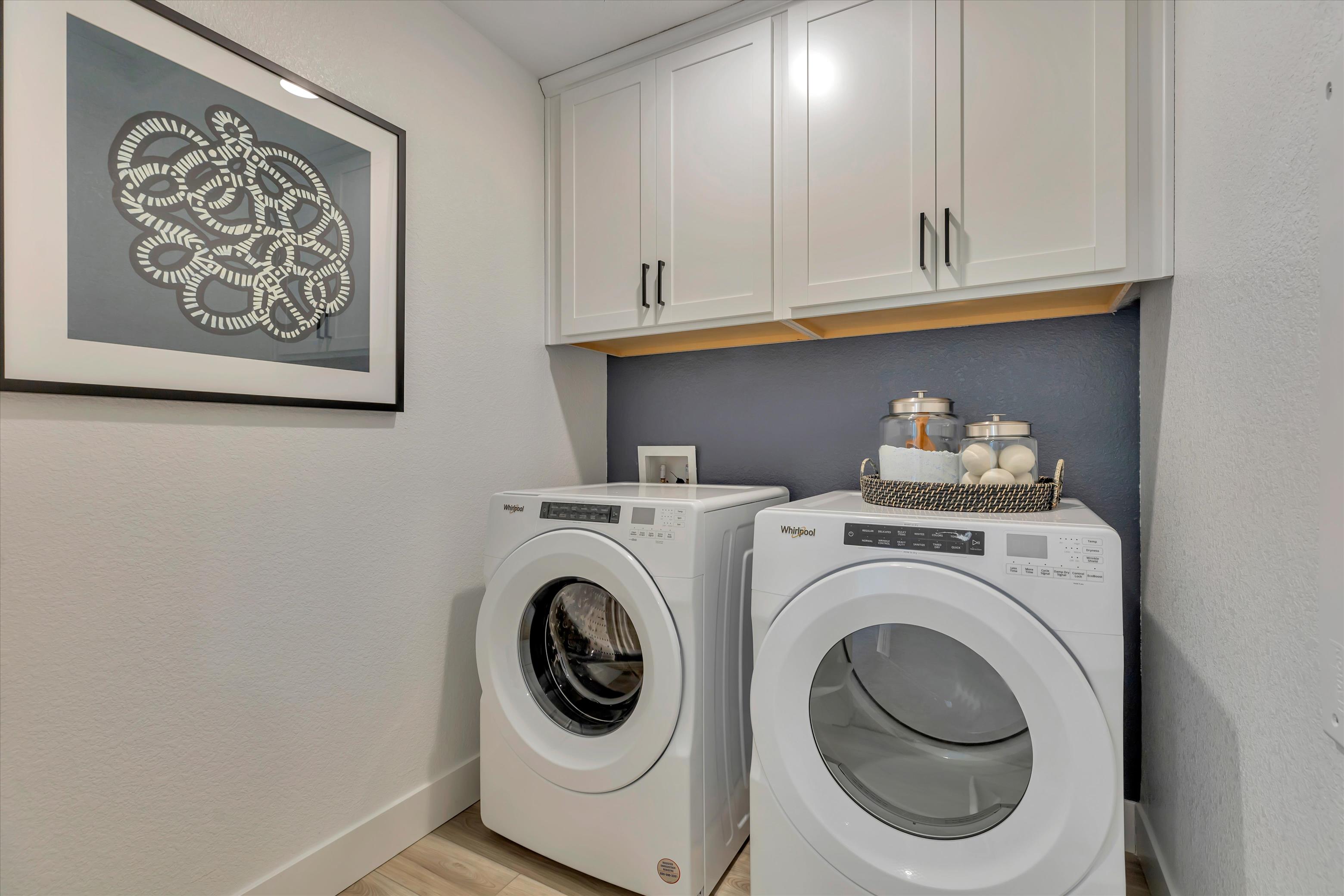 A washing machine and dryer in a room.