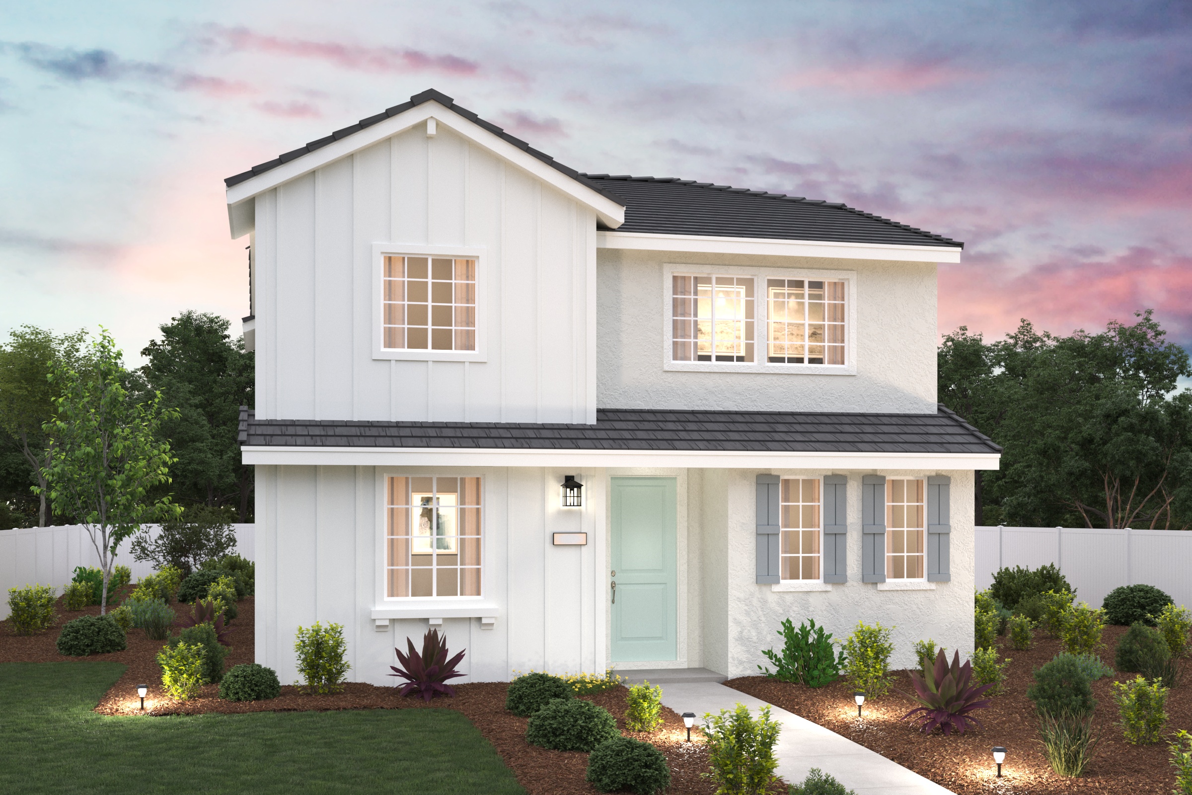 A white house with a green lawn.