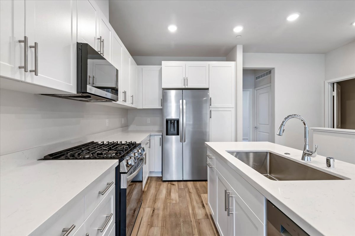 A kitchen with white cabinets.