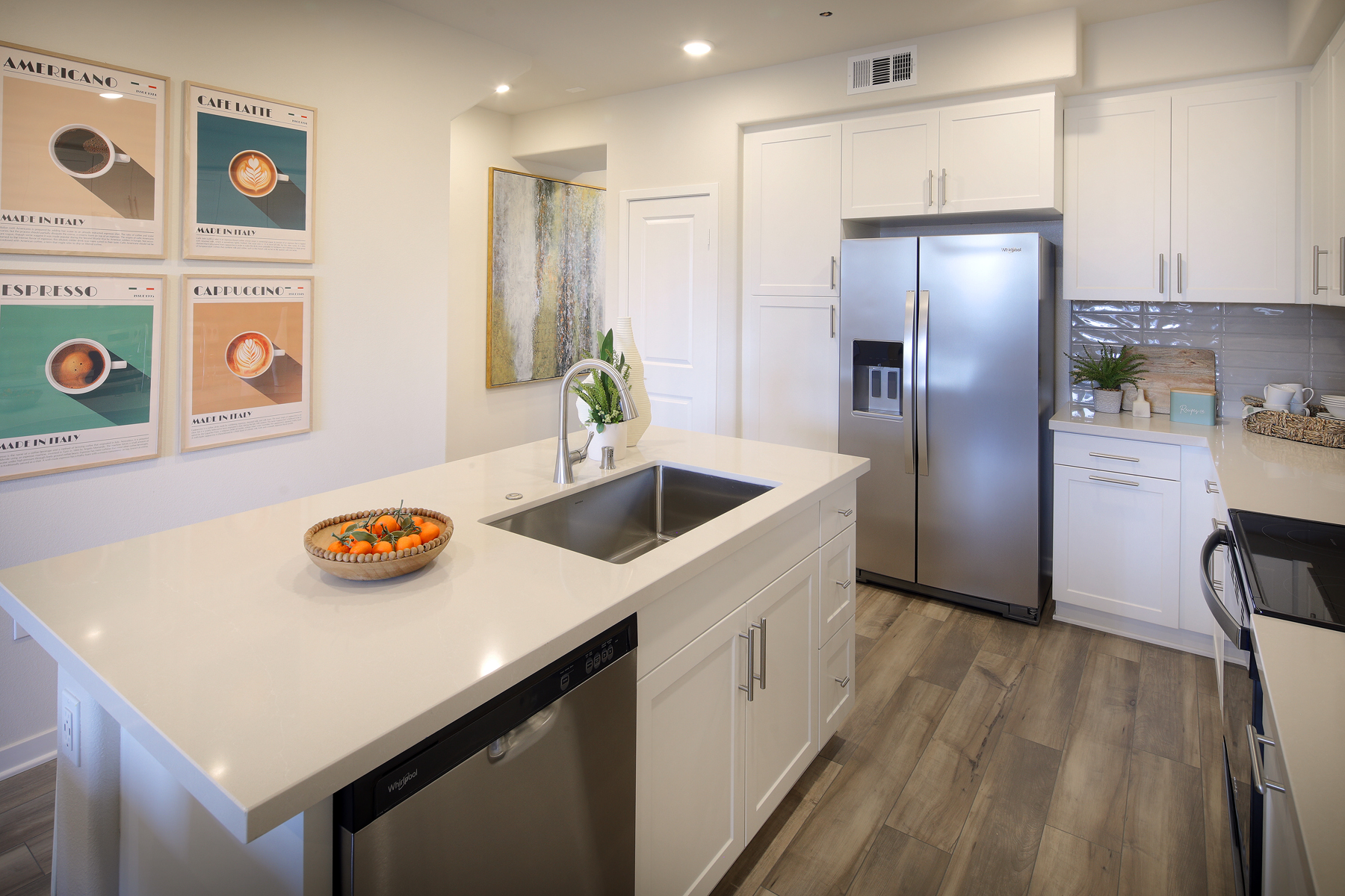 A kitchen with white cabinets.
