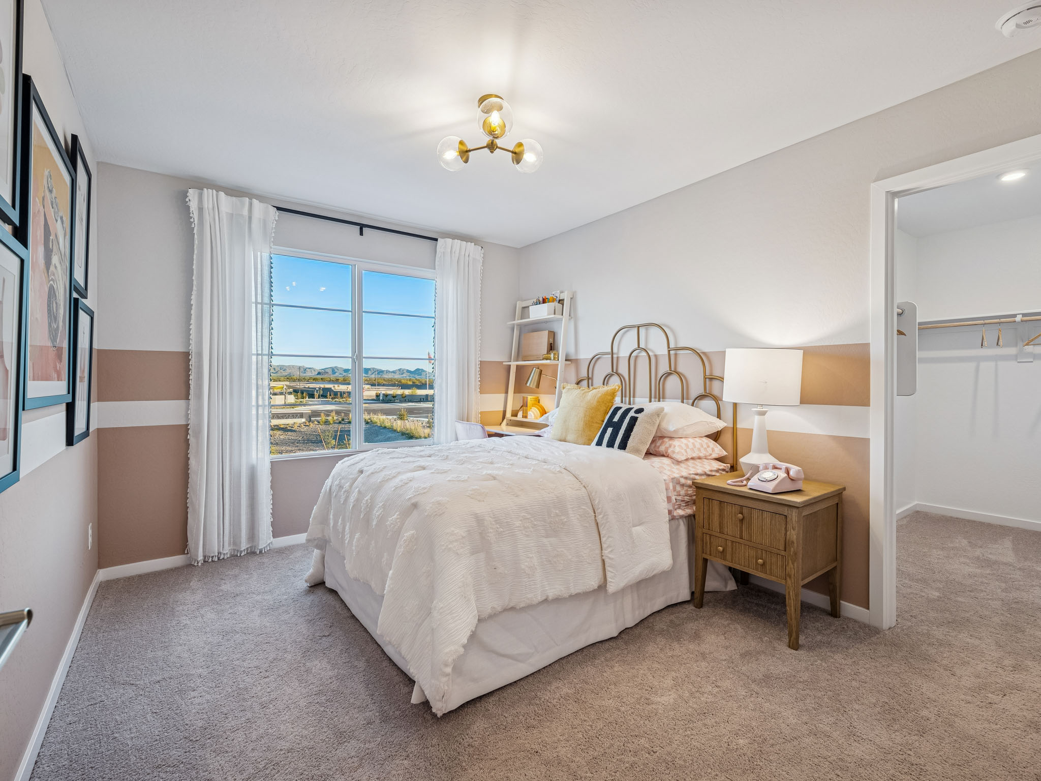A bedroom with a large window.