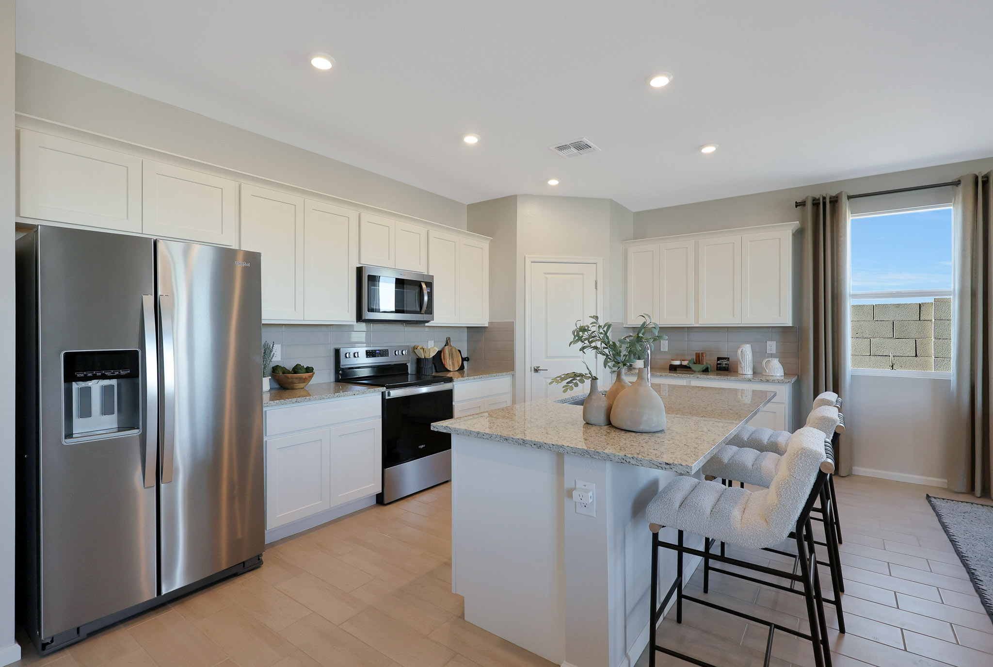 A kitchen with white cabinets.