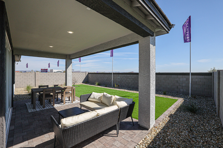 A patio with a patio and a table and chairs and a large window.