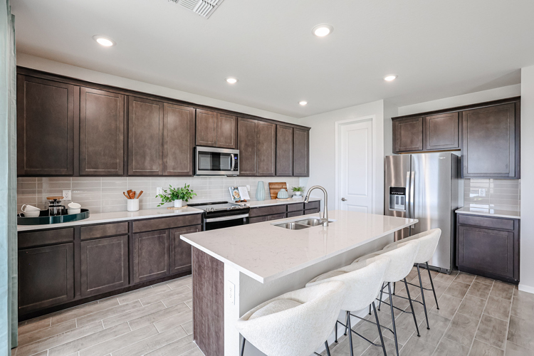 A kitchen with a table and chairs.