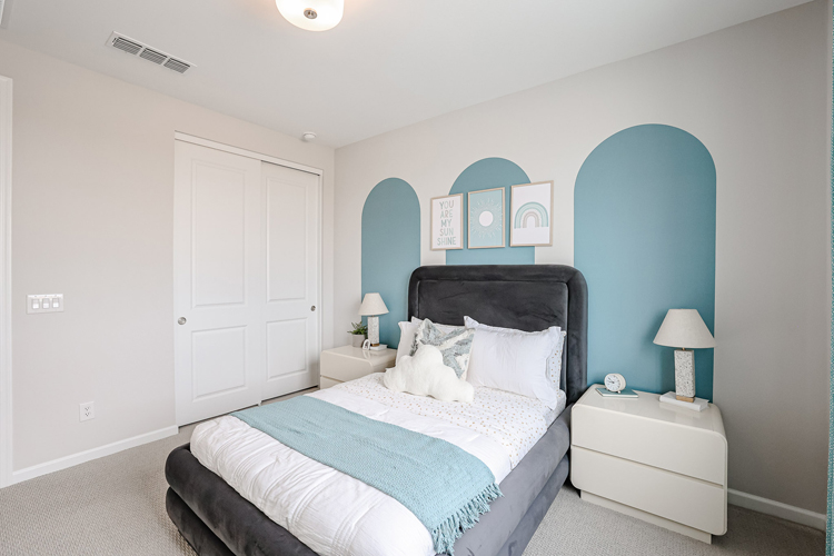 A bedroom with a bed and lamps.