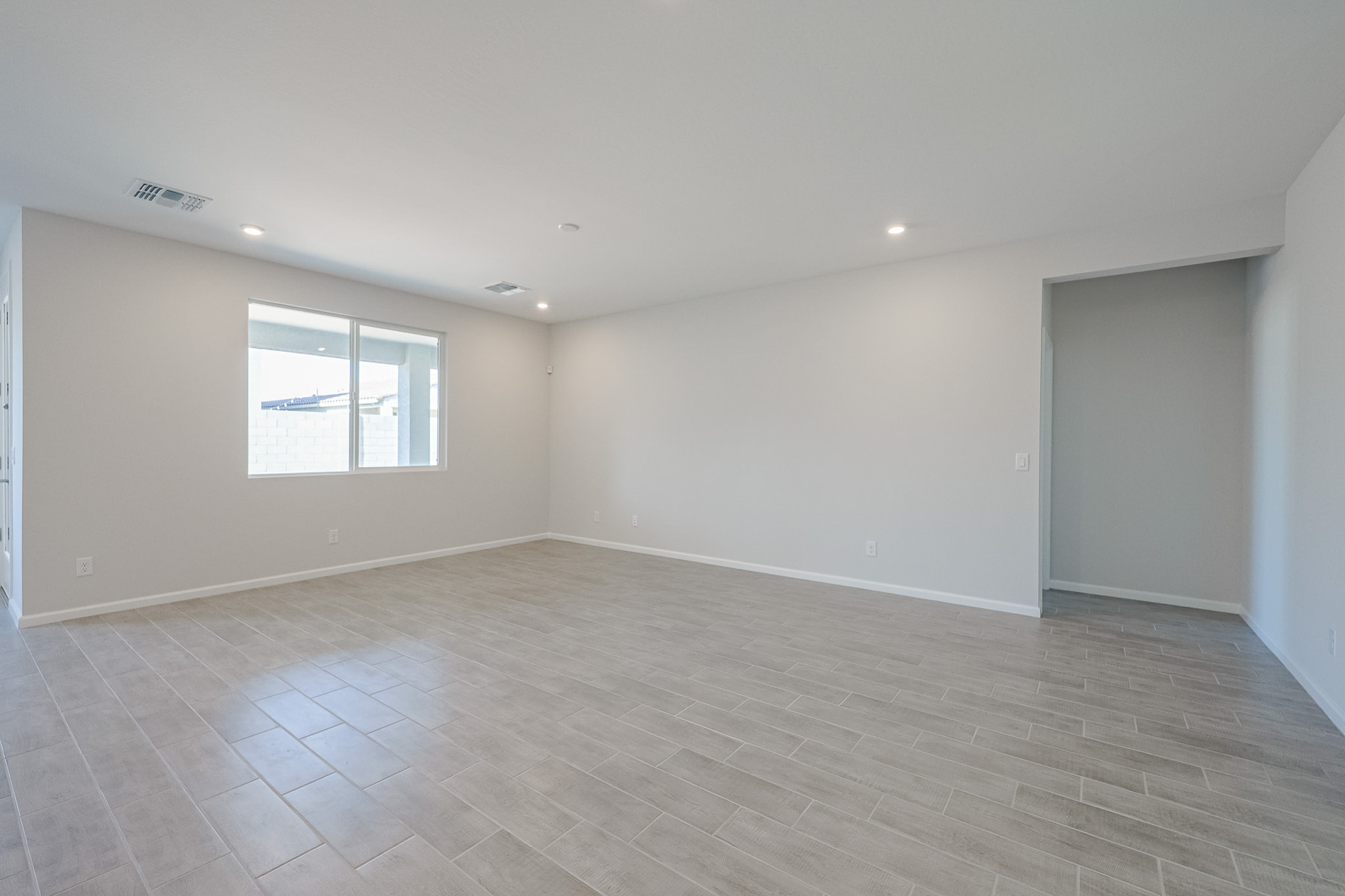A room with a tile floor and a window.