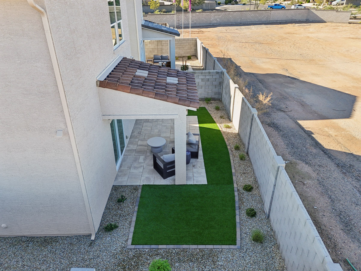 A small patio with a bench and a small pool.