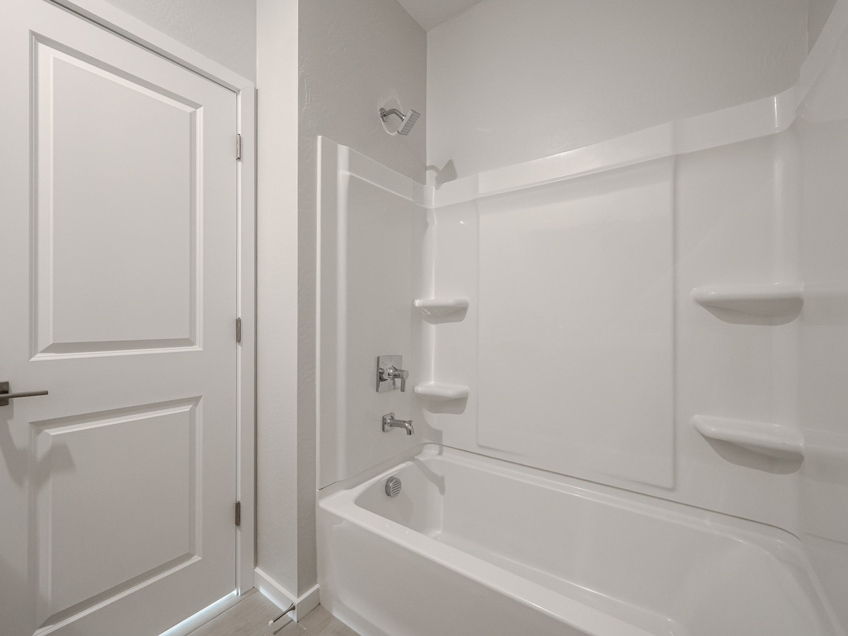 A bathroom with a bathtub sink and toilet.