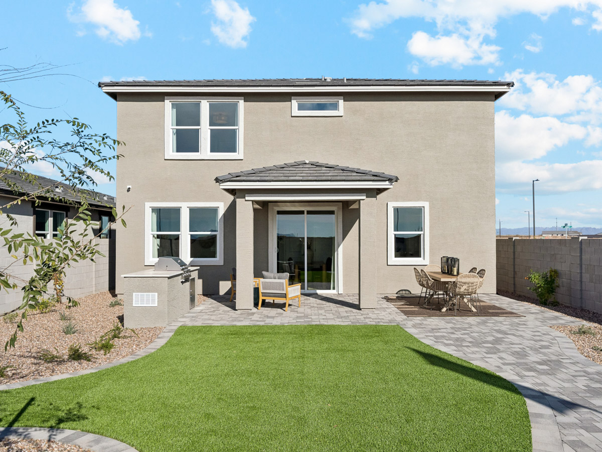 A house with a lawn and chairs.