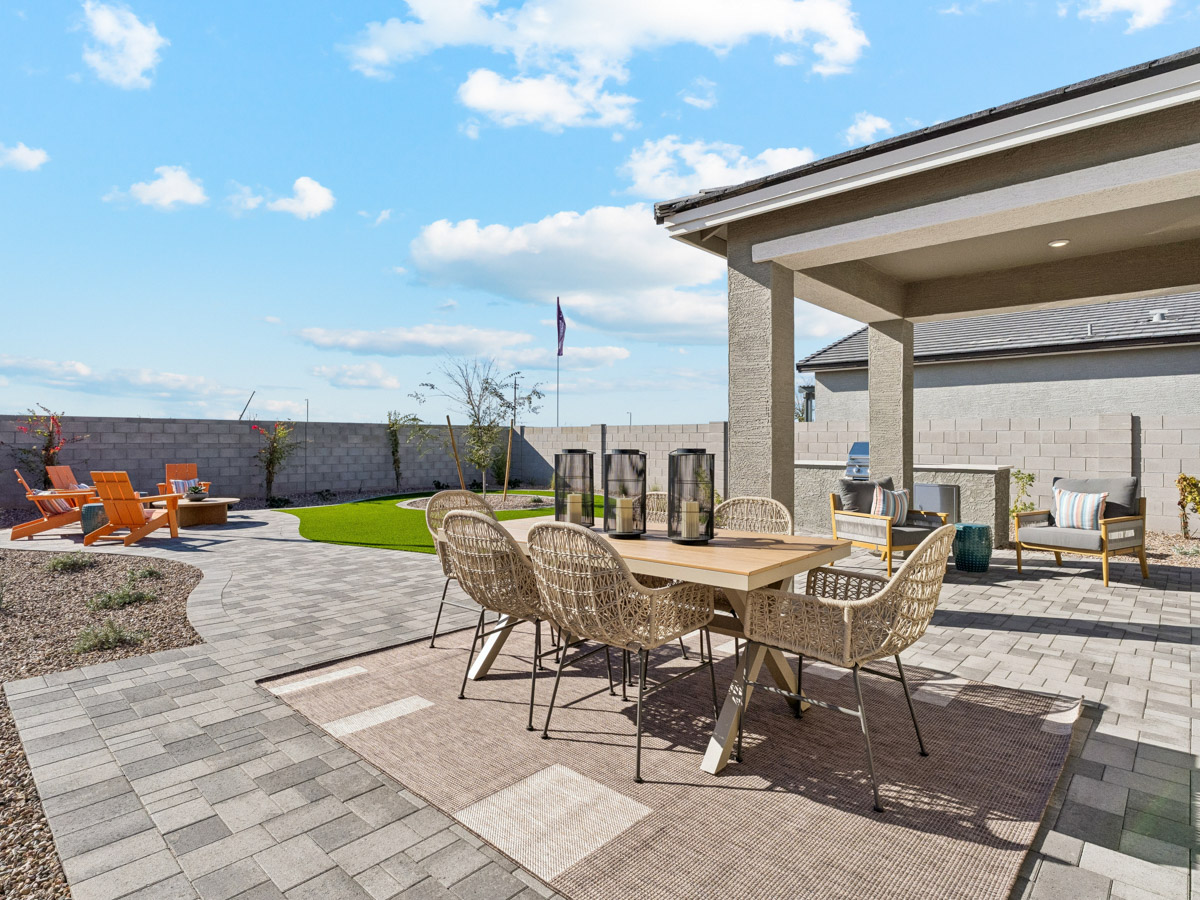 A patio with a table and chairs.