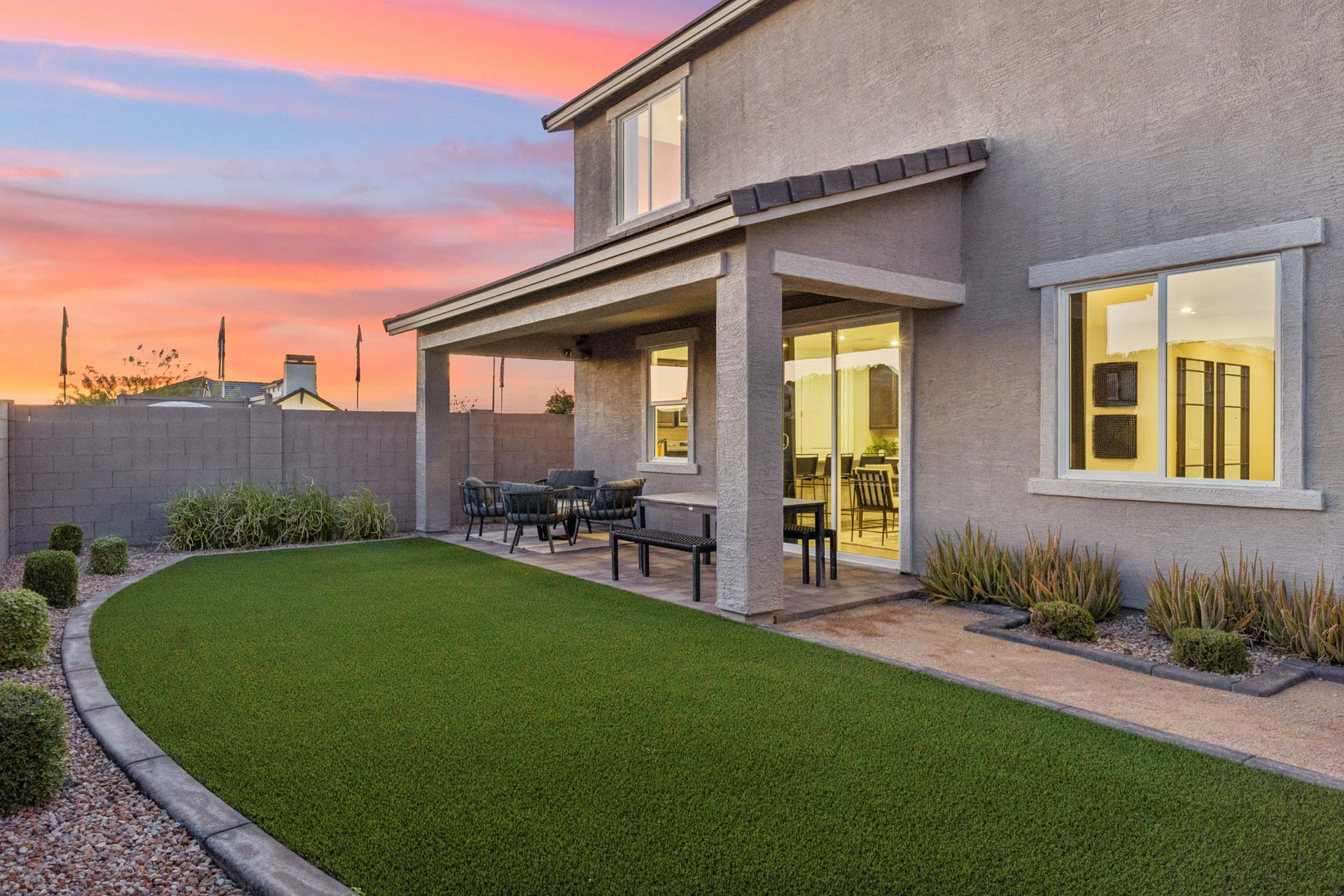 A house with a lawn and chairs.