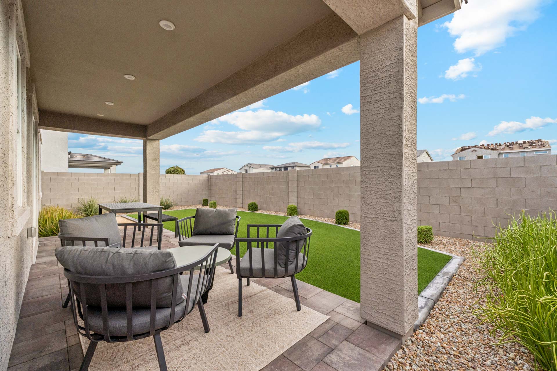 A patio with chairs and tables.