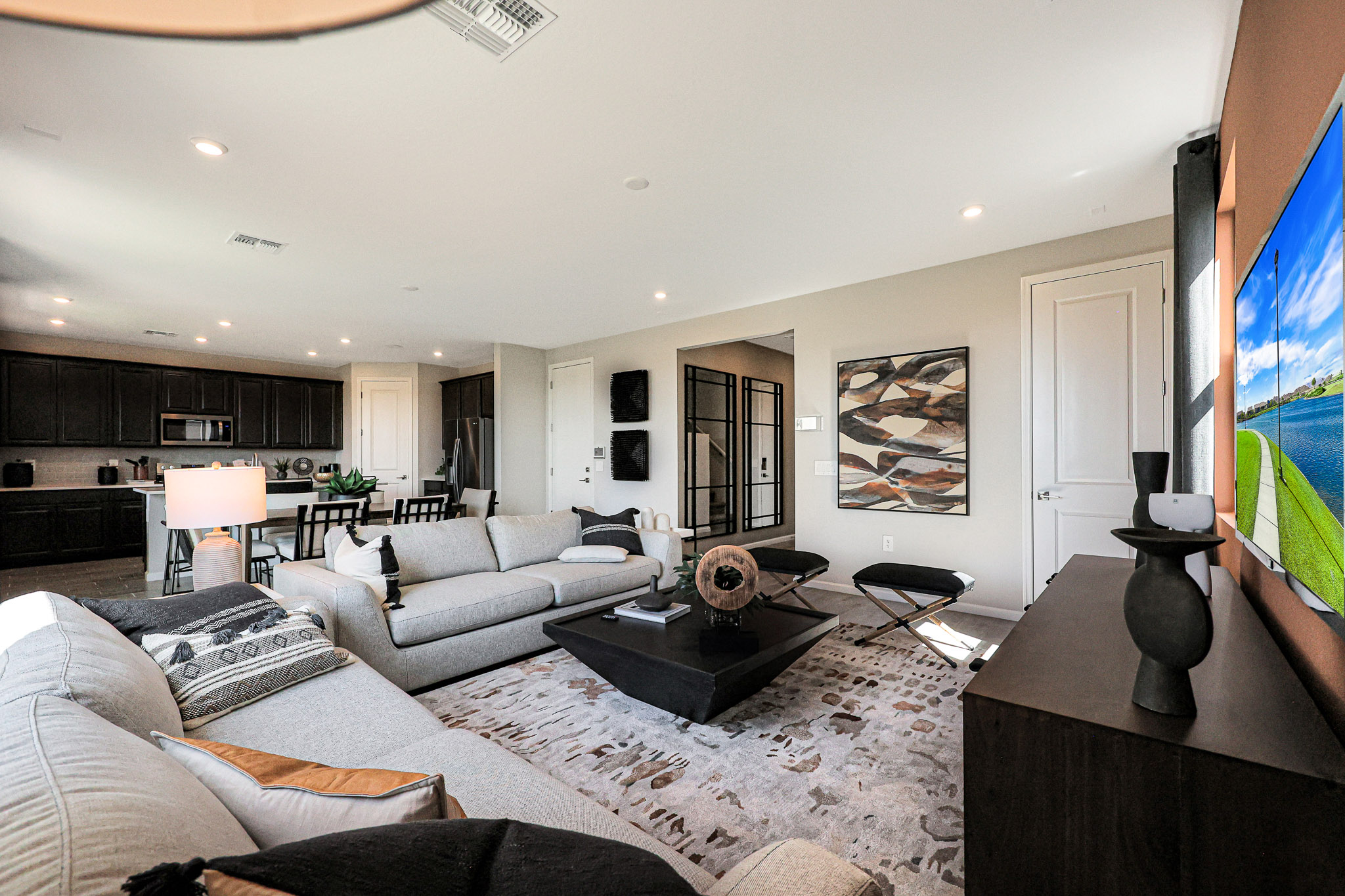 A living room with a large television.