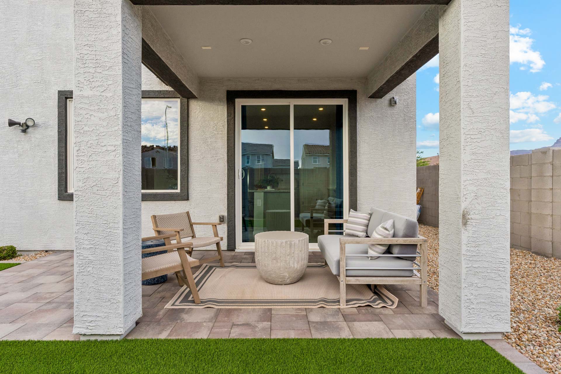 A house with a patio and a large glass door.