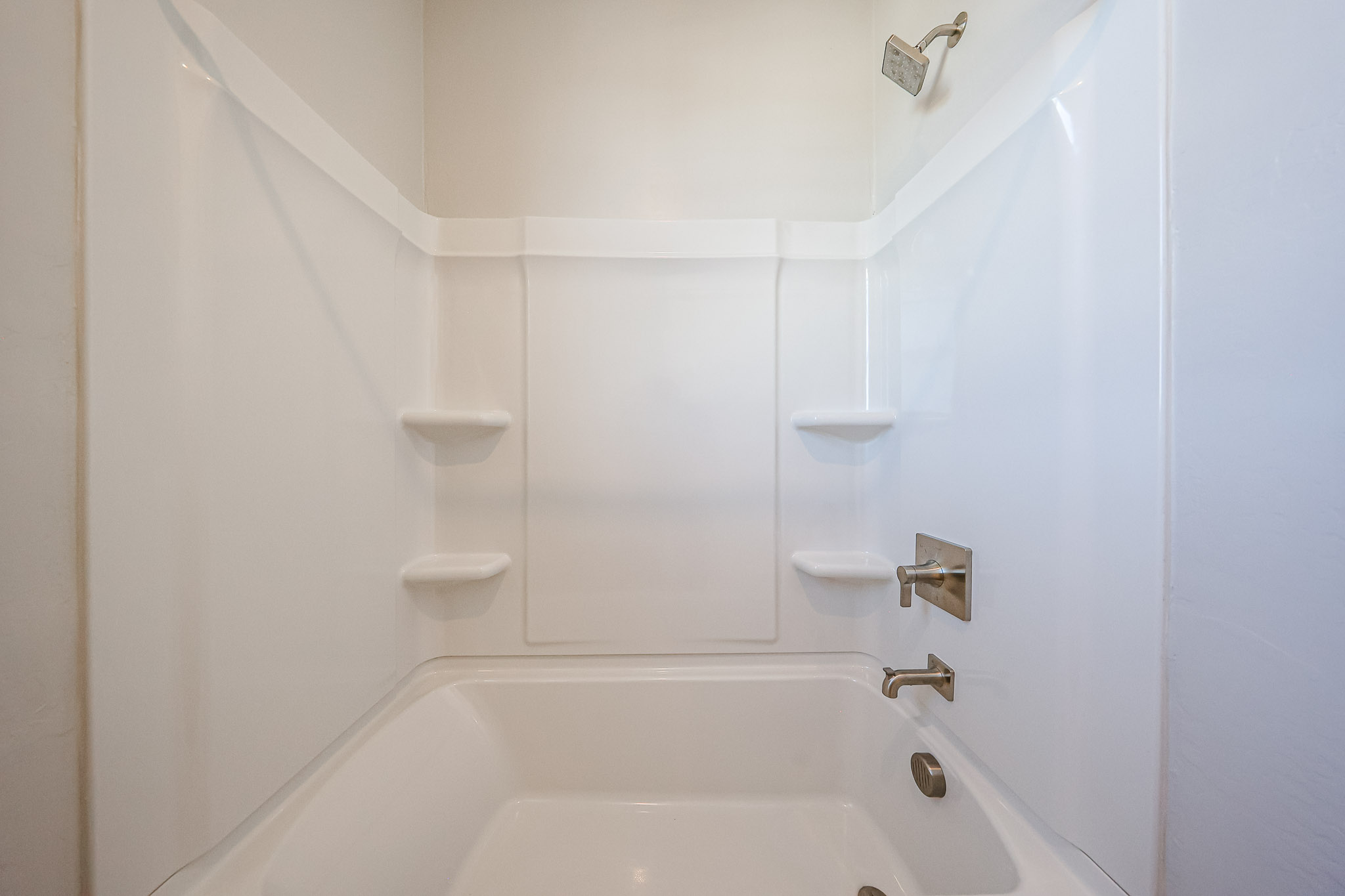 A bathtub with a sink and a toilet.