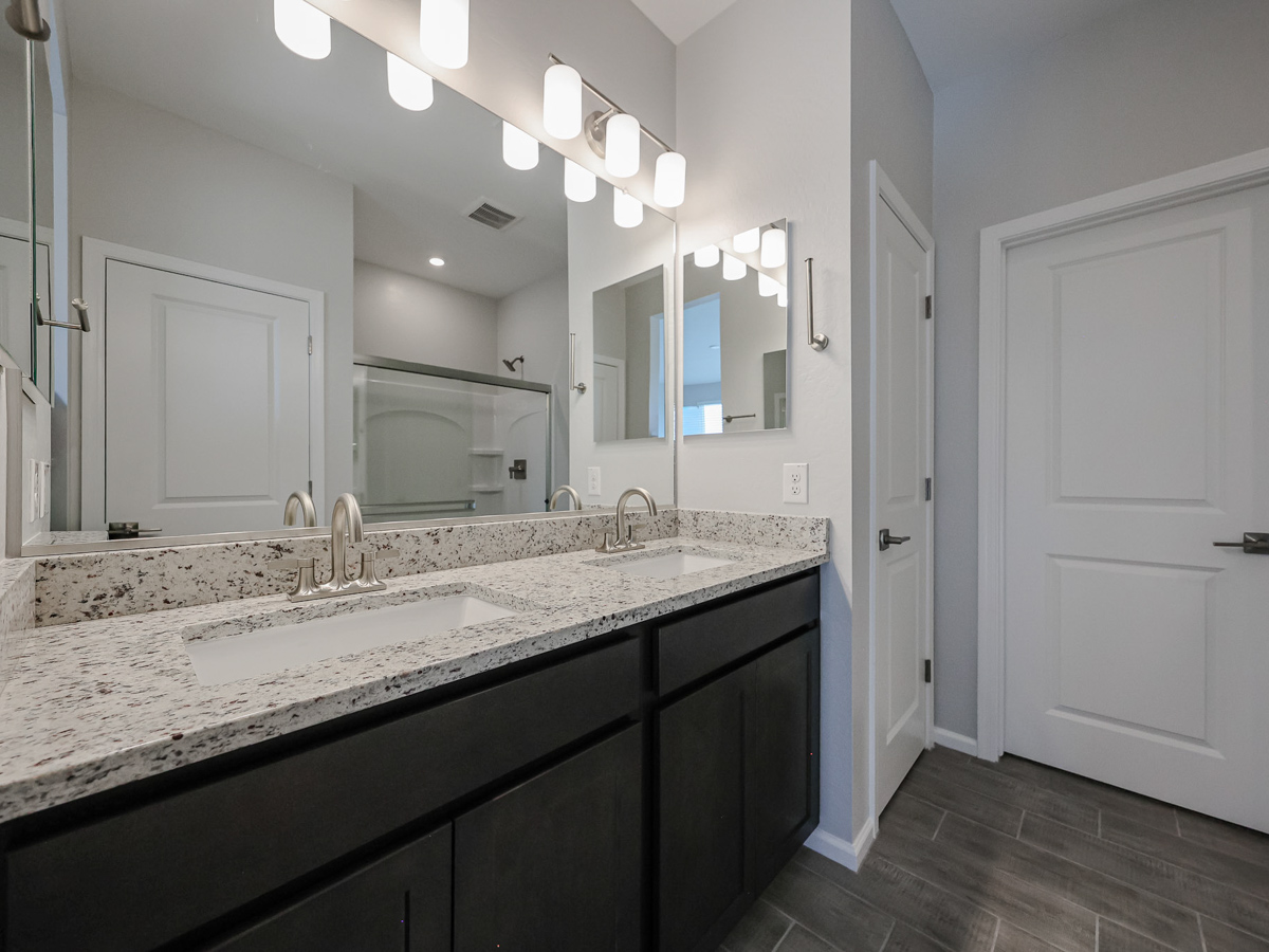A bathroom with a marble countertop.