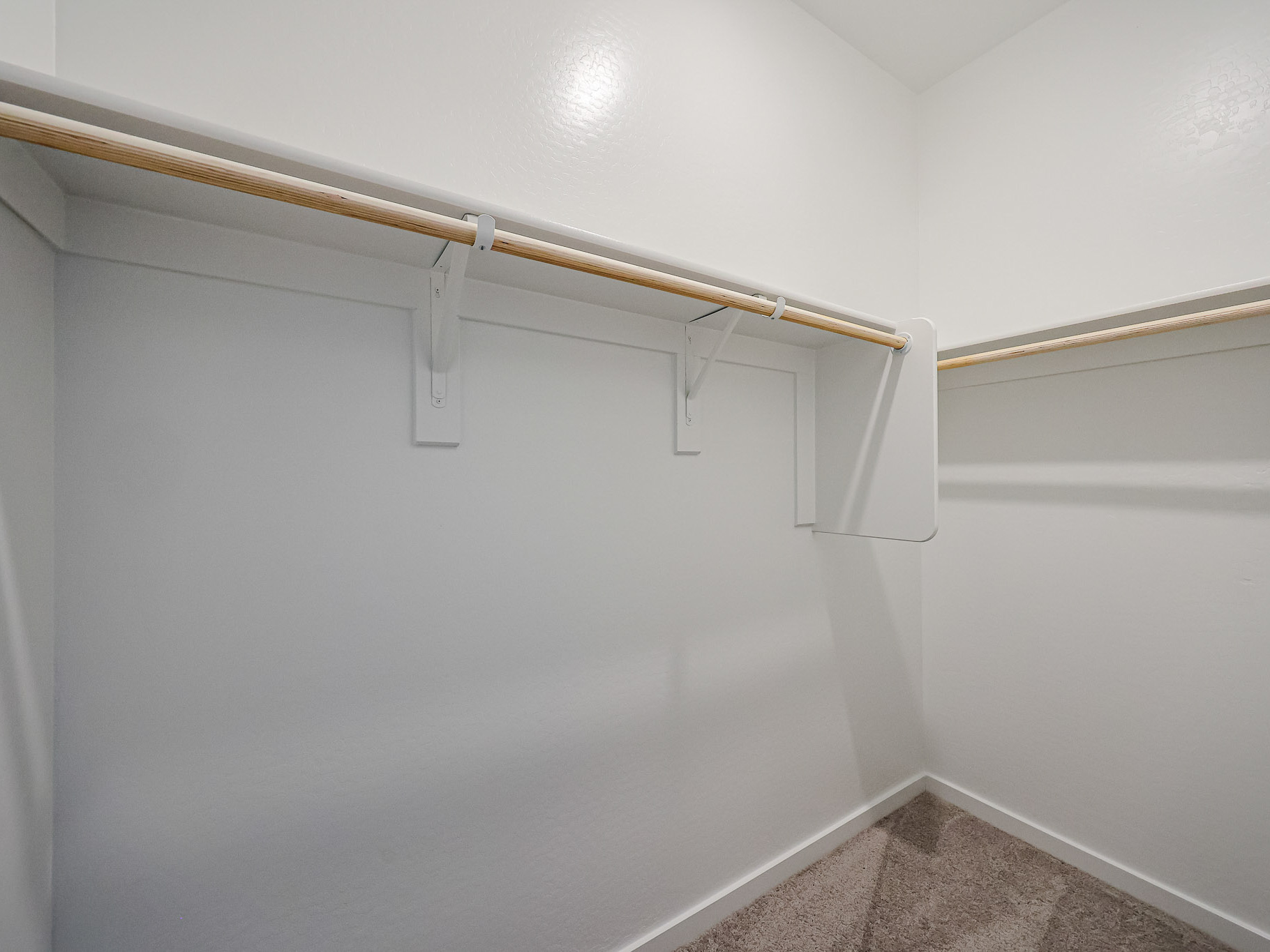 A white wall with a wooden cross.