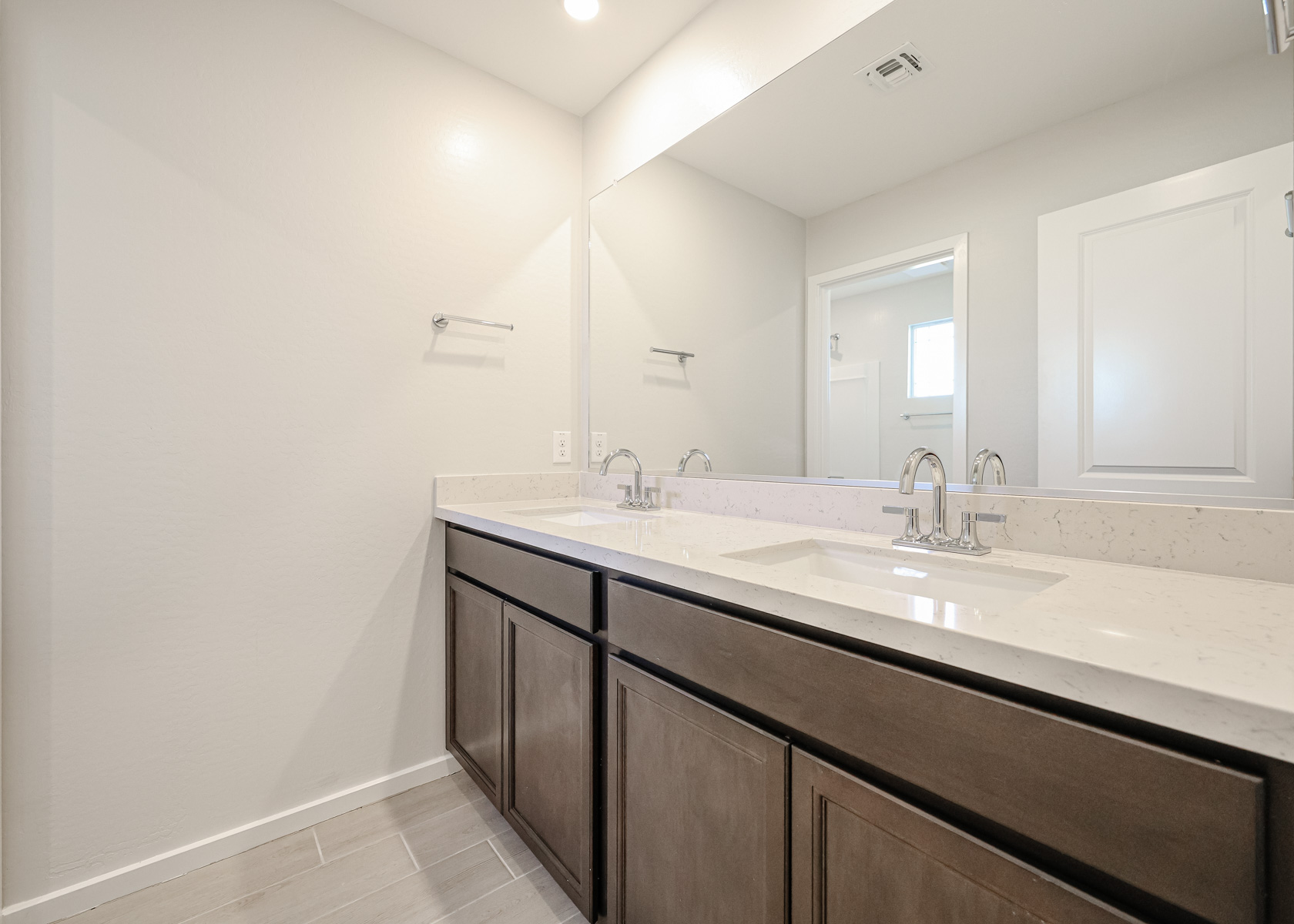 A bathroom with a large mirror.