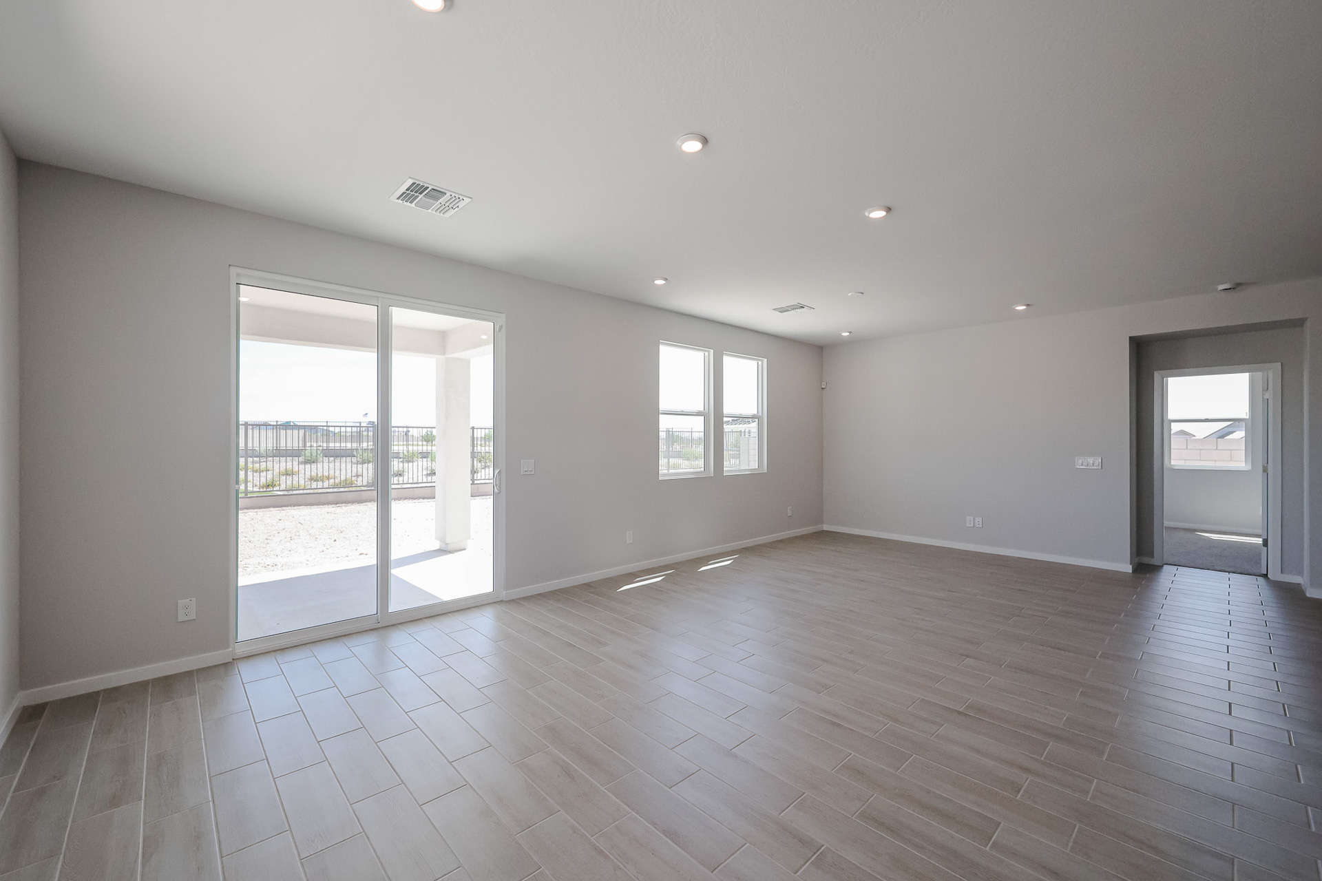 A room with a wood floor and a glass door.