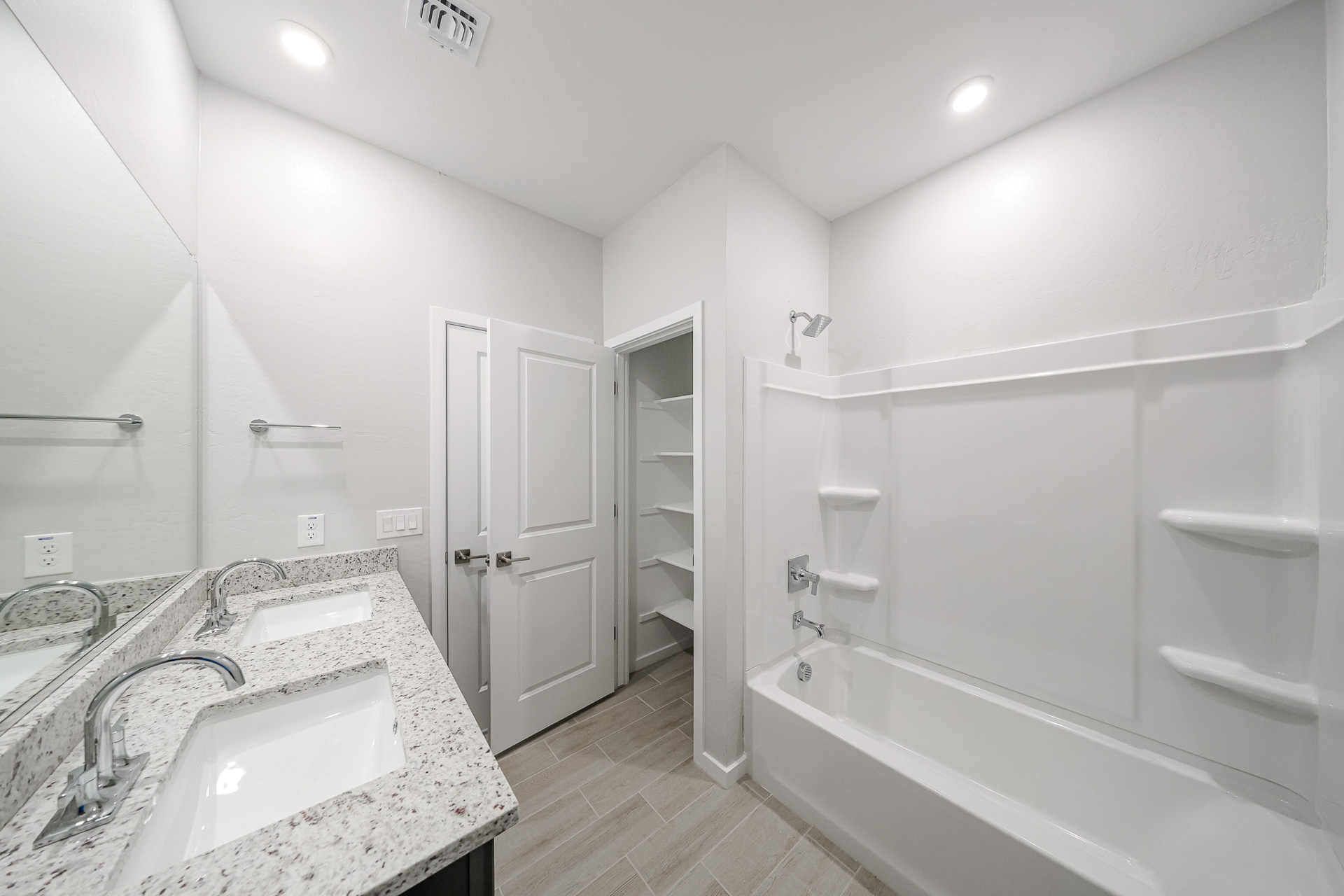 A bathroom with a tub sink and a bathtub.