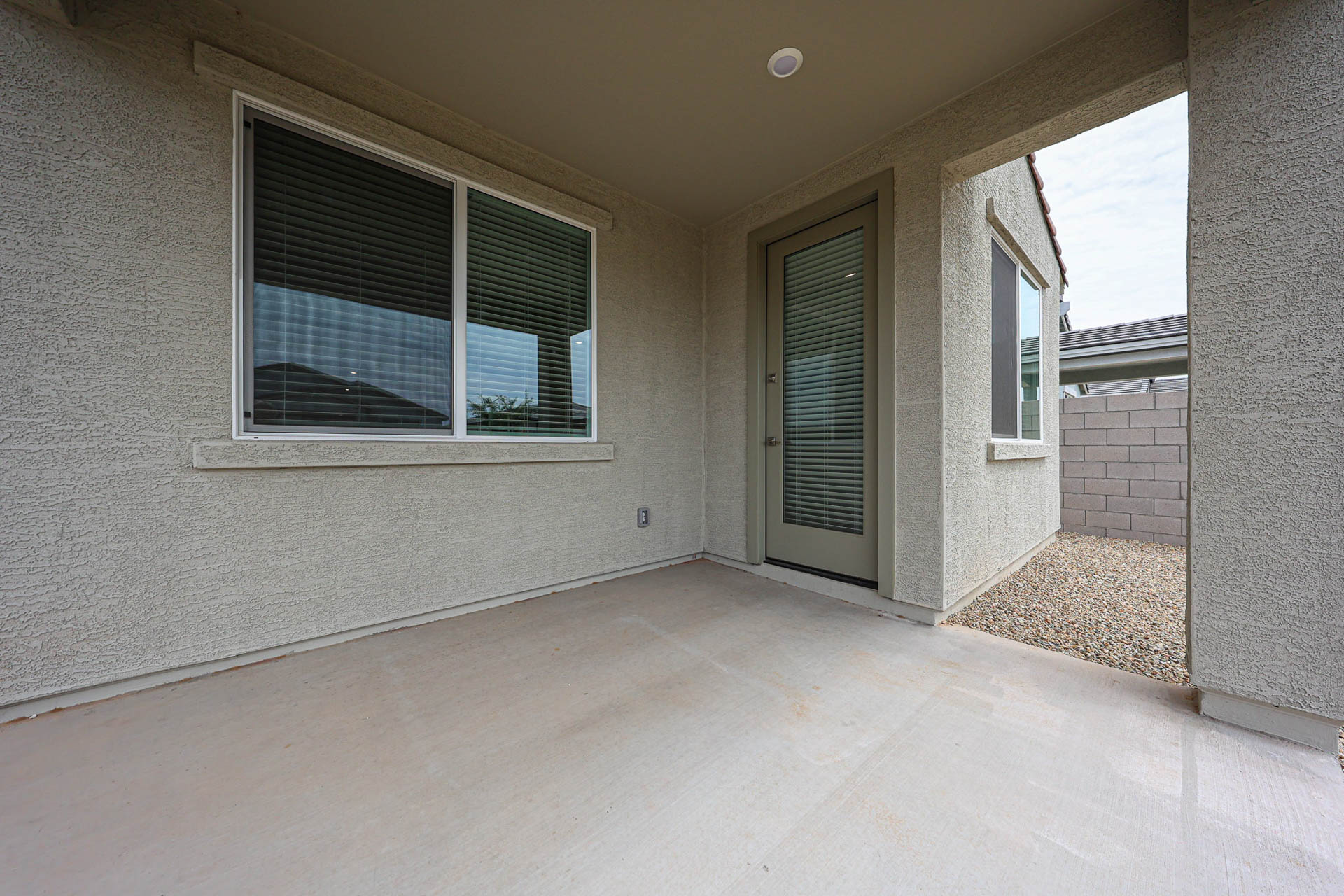 A room with windows and a rug.