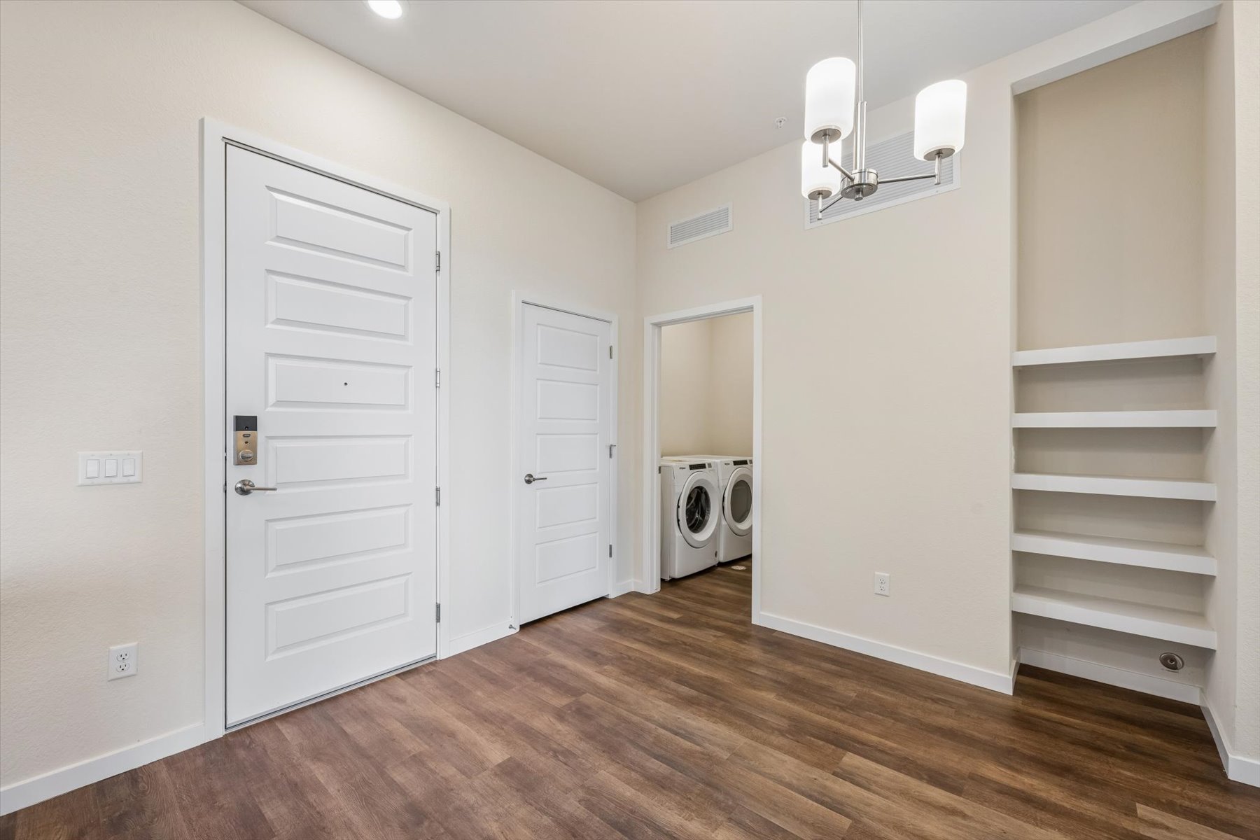 A room with white cabinets and a white door.
