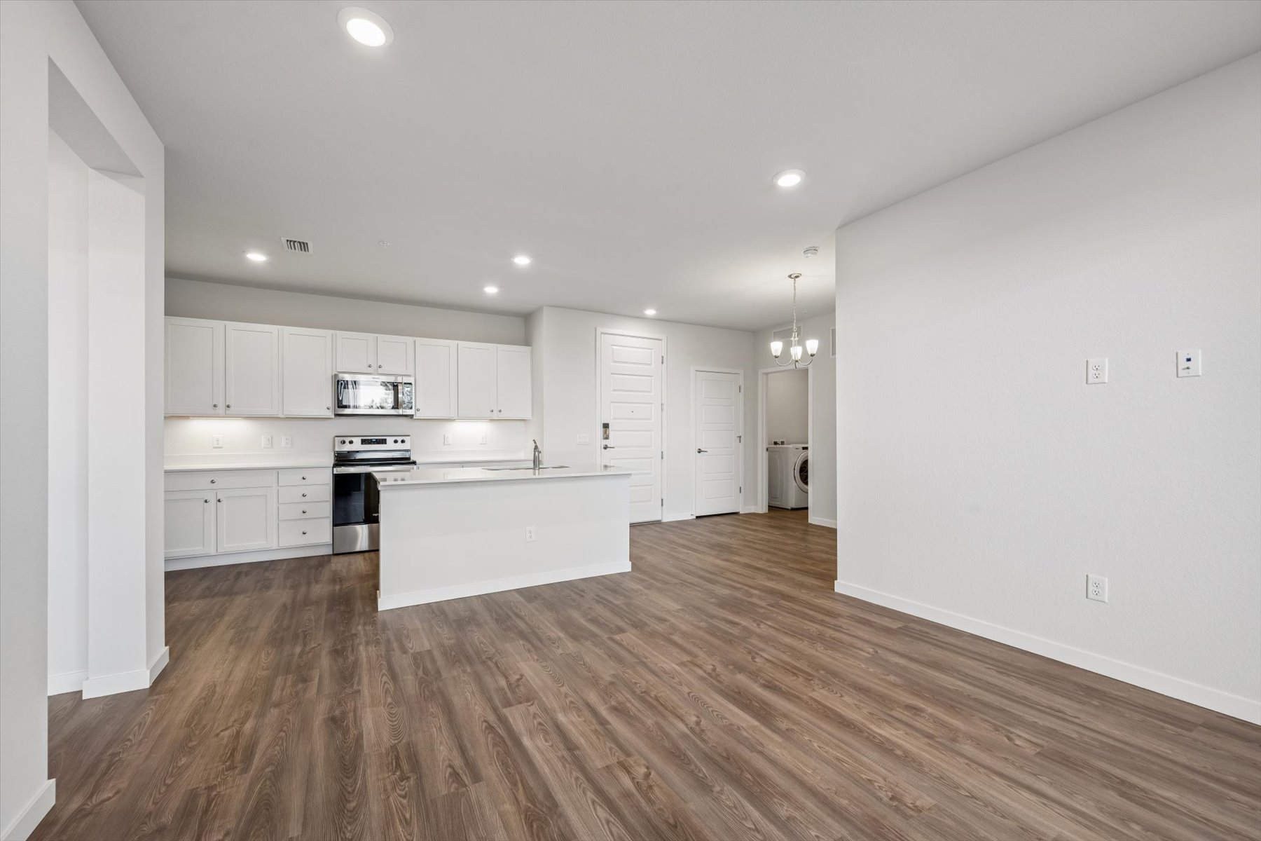 A kitchen with white cabinets.