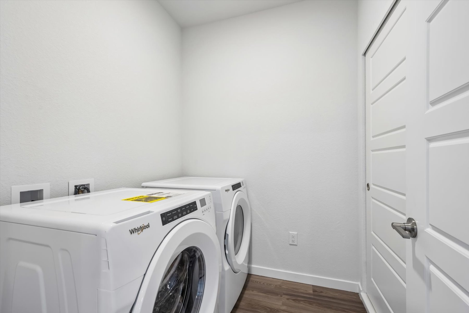 A white washing machine in a room.