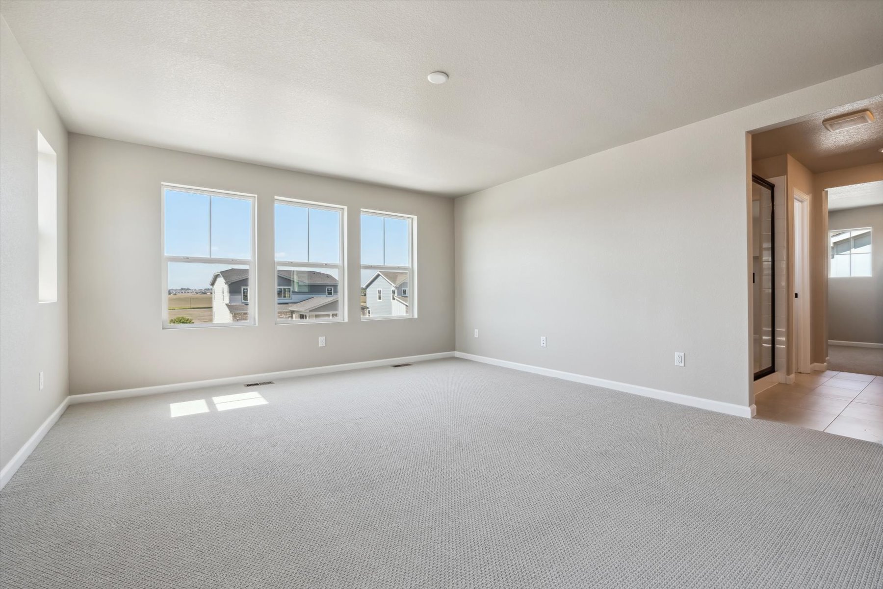 A large empty room with a large window.