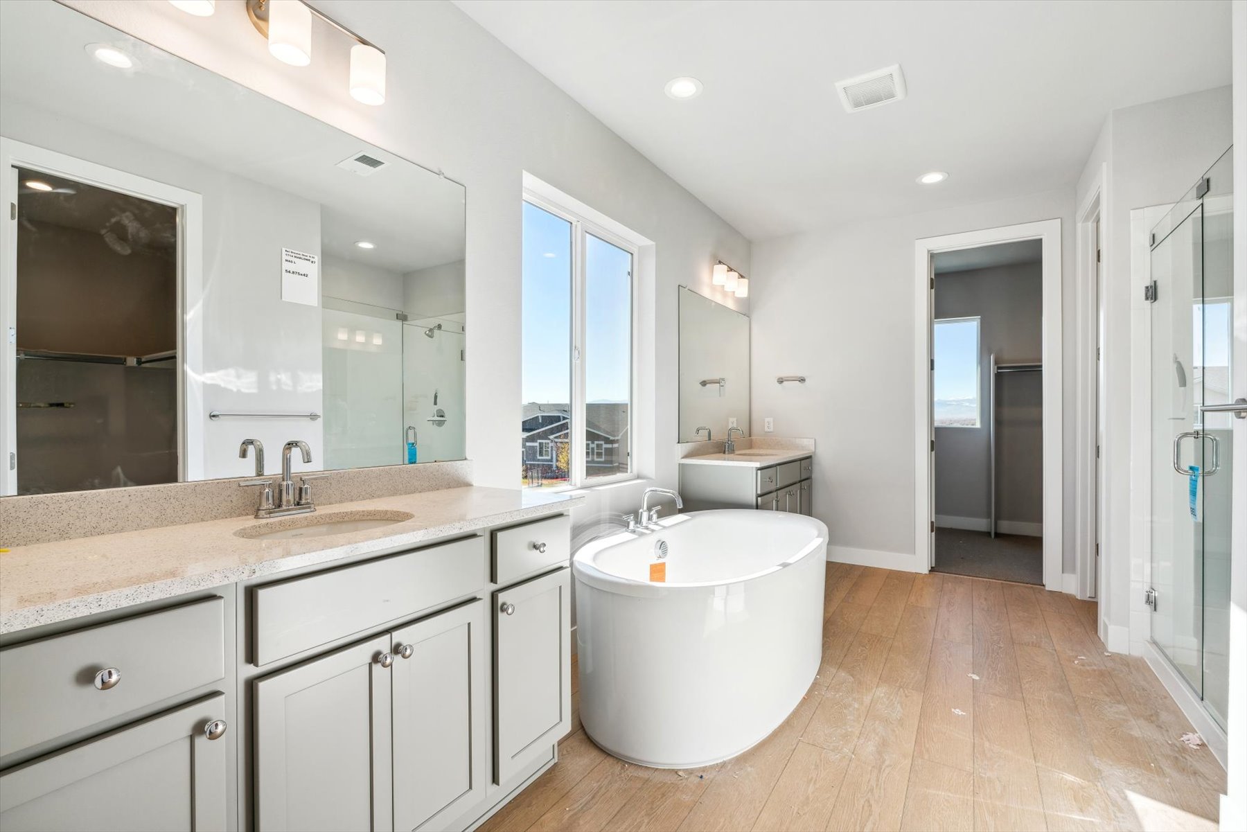A bathroom with a large mirror.