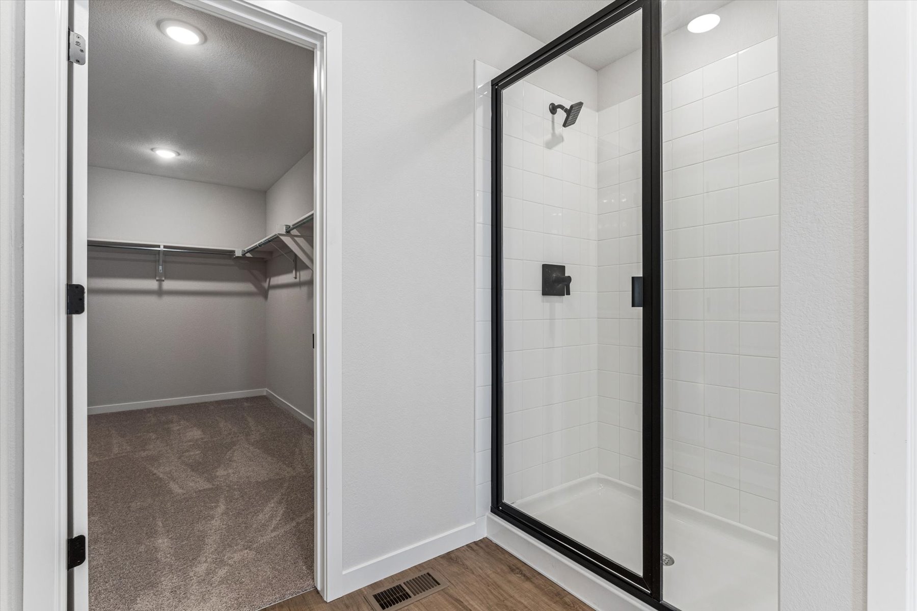 A shower with a glass door.