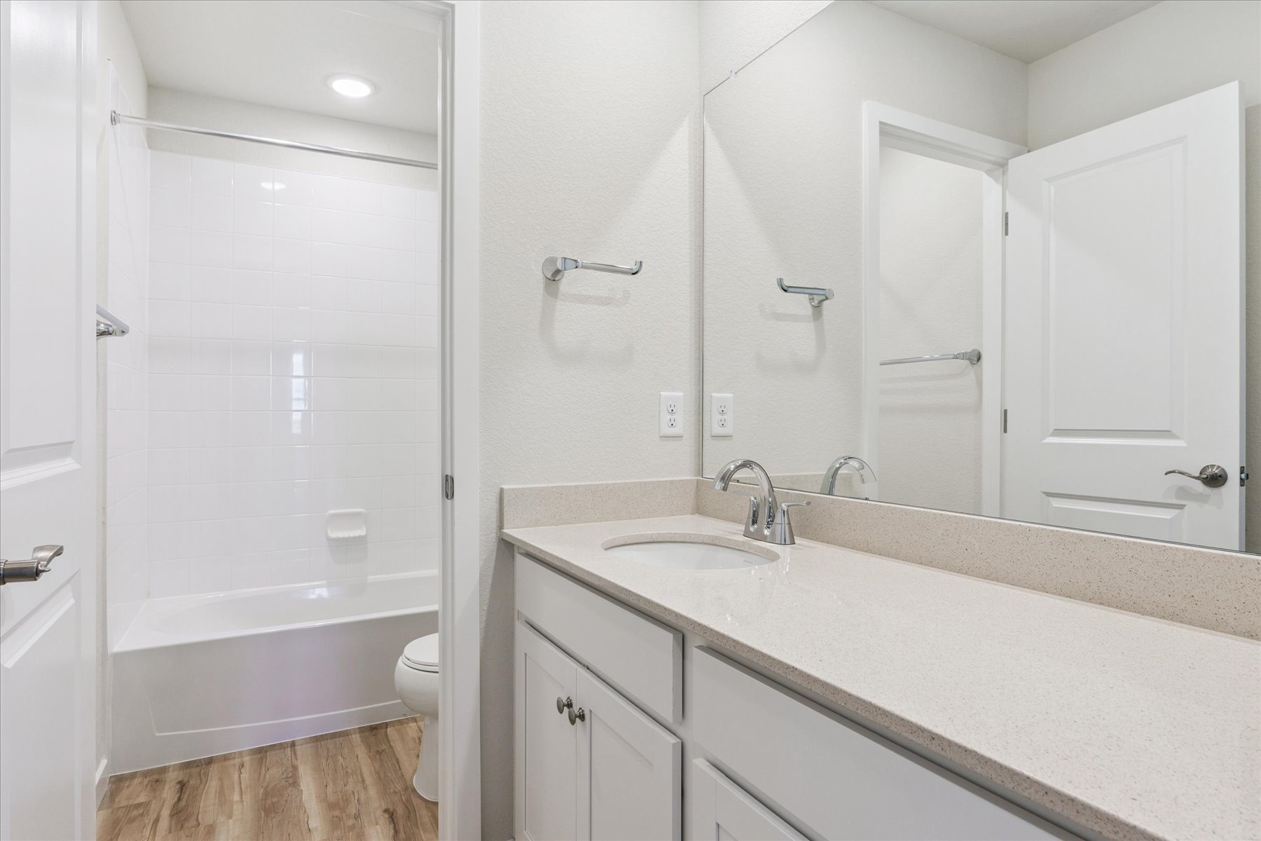 A bathroom with a sink toilet and shower.