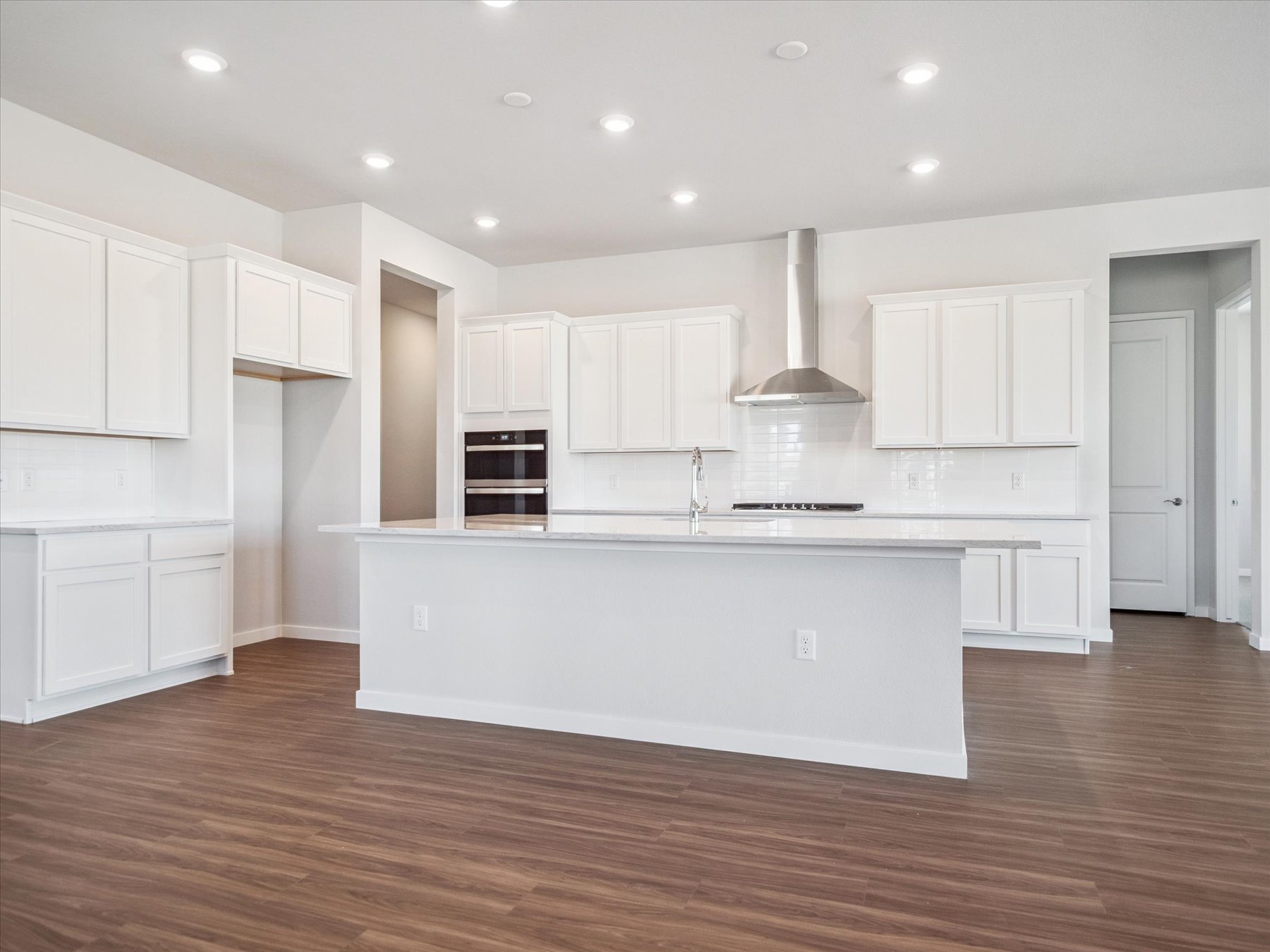 A kitchen with white cabinets.