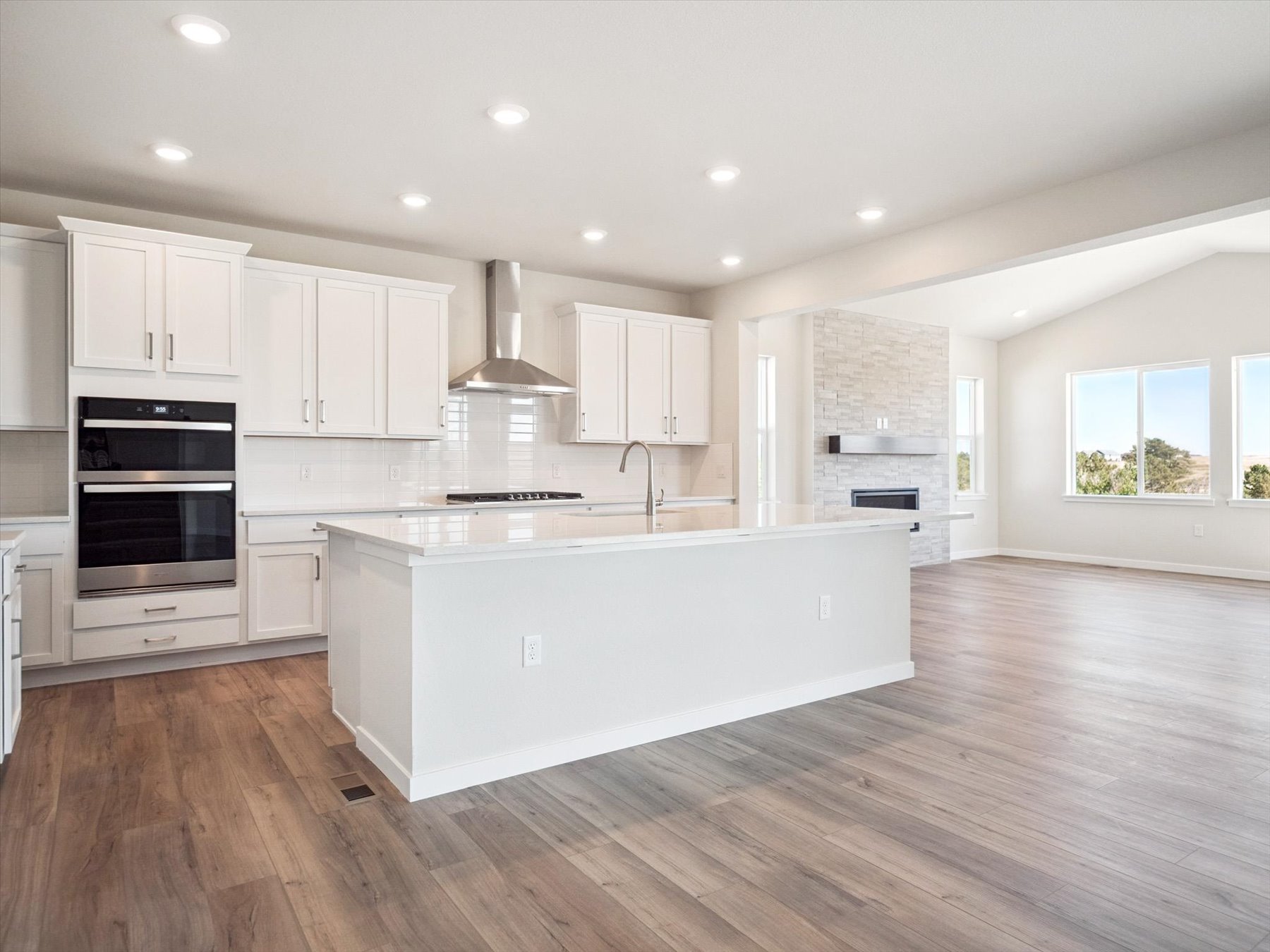 A kitchen with white cabinets.