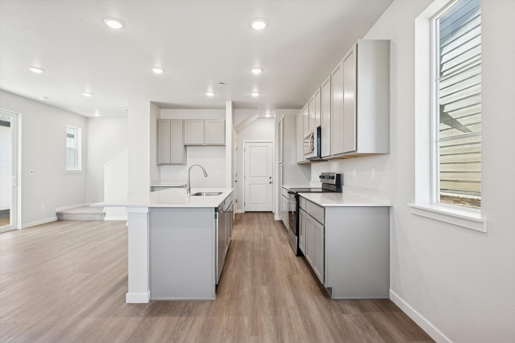 A kitchen with white cabinets.