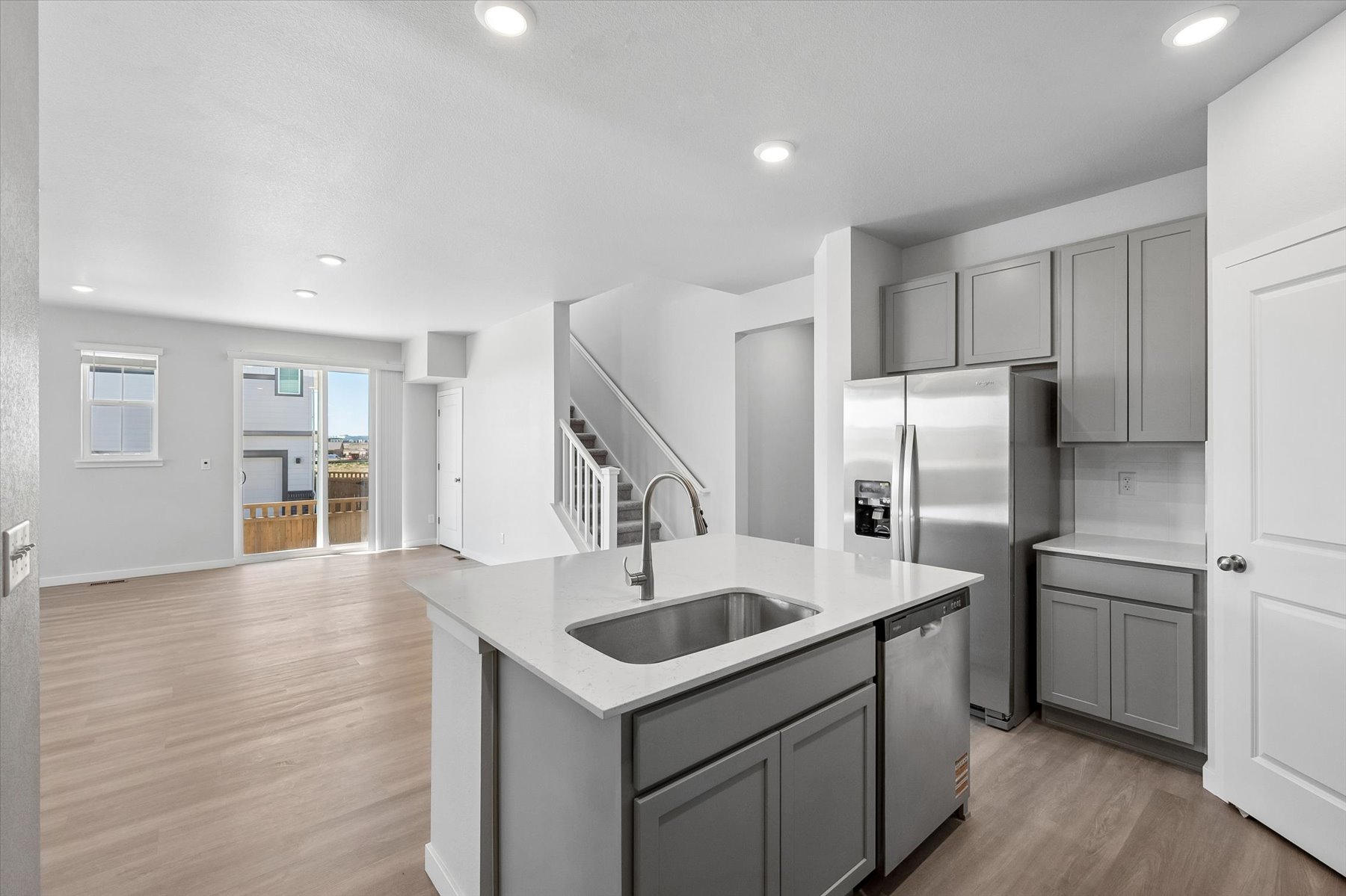 A kitchen with white cabinets.