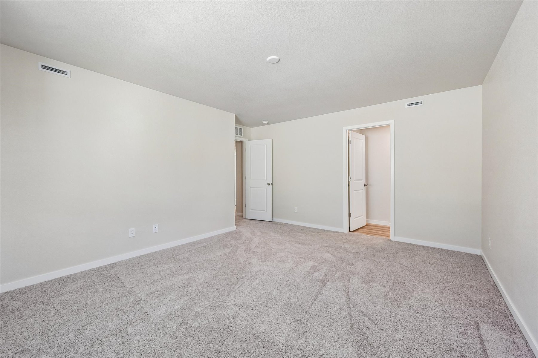 A hallway with white doors.