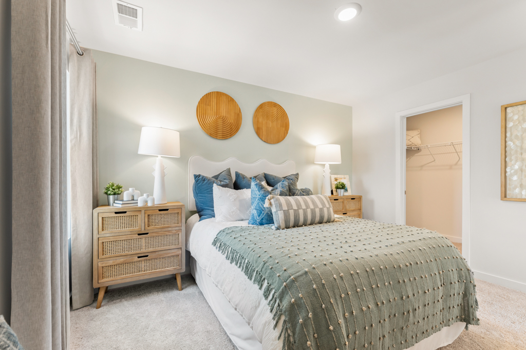 A bedroom with a bed and lamps.