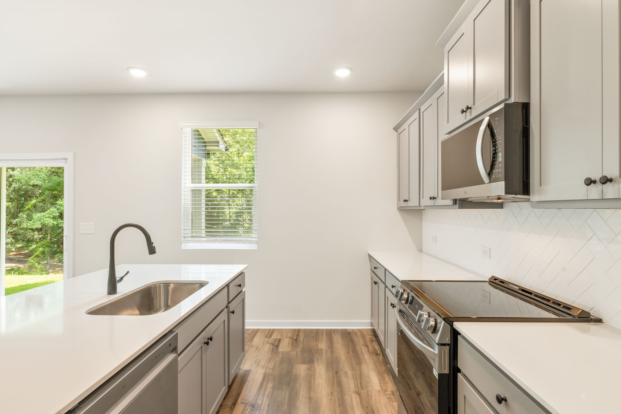 A kitchen with white cabinets.