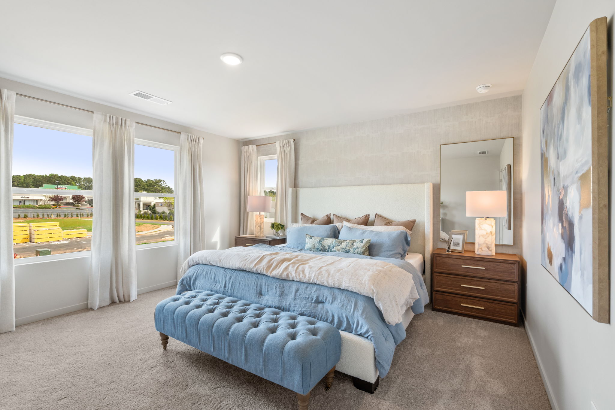 A bedroom with a large window.