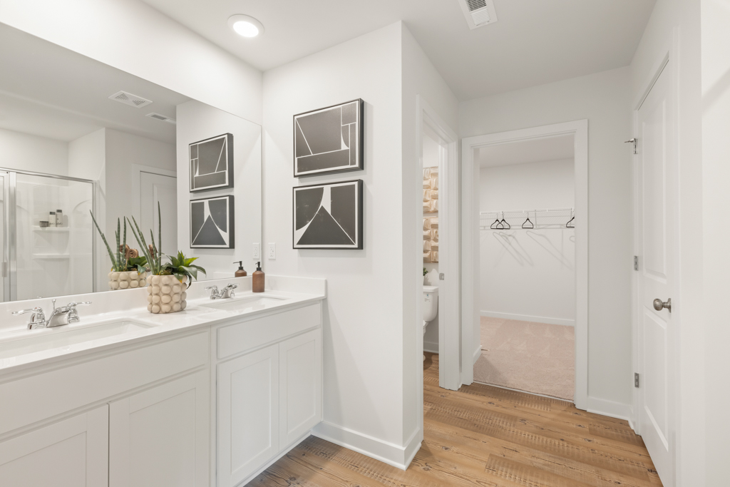 A bathroom with white cabinets.