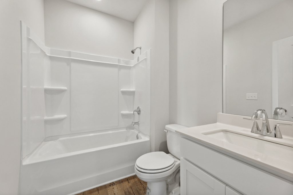 A bathroom with a tub toilet and sink.