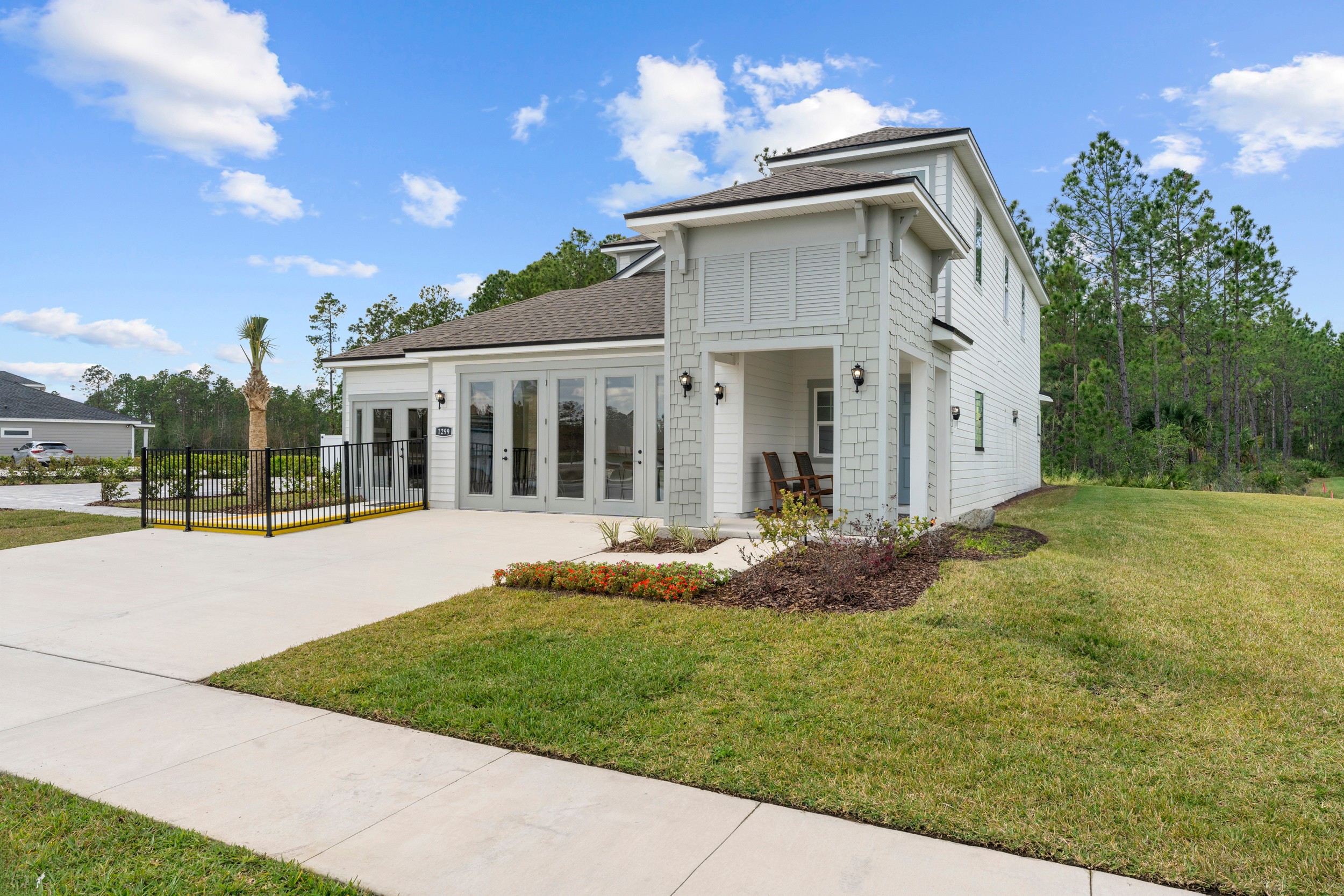 A white house with a driveway.