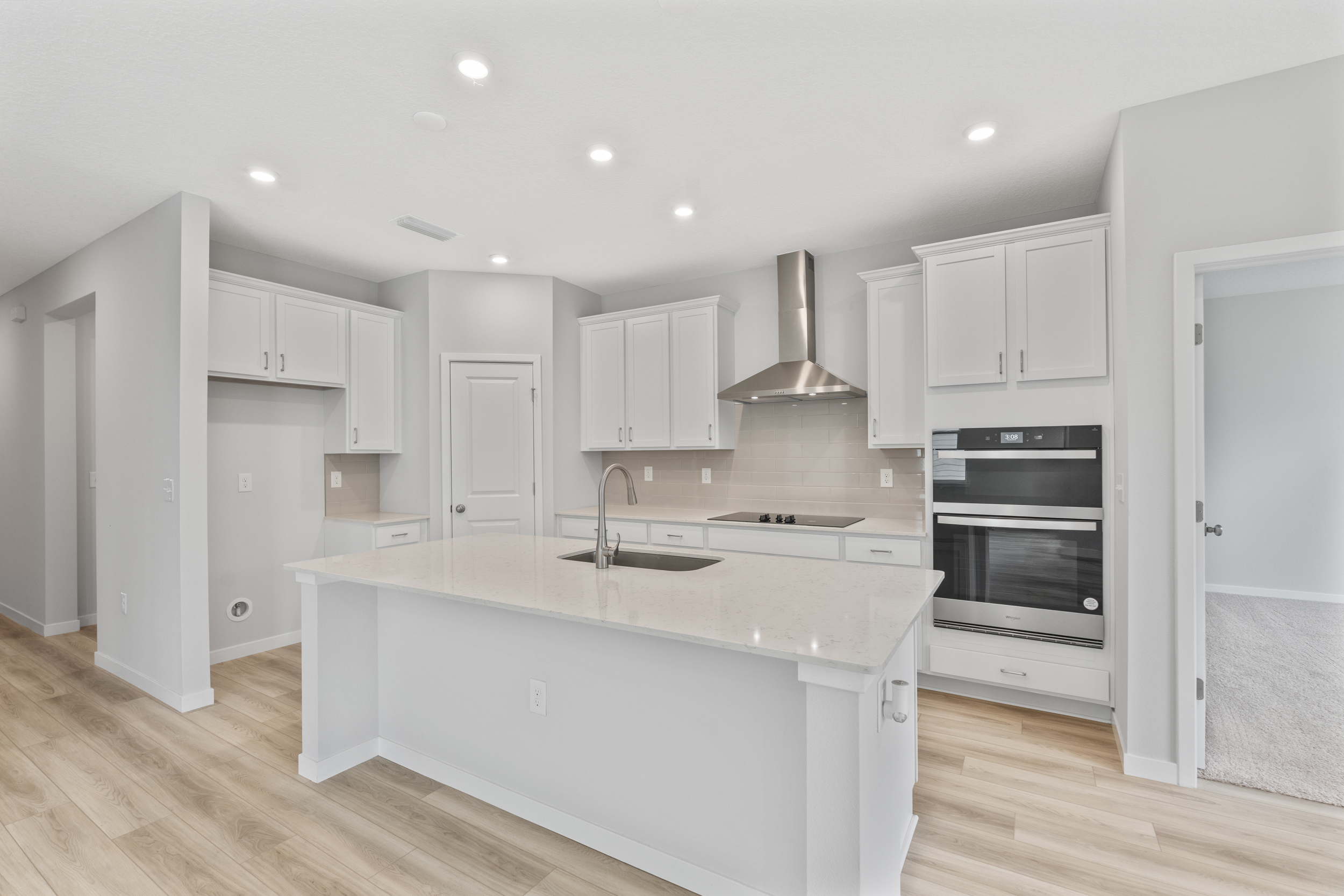 Palmetto Floorplan Lot 145 Kitchen with White Cabinets at Seminole Palms in Palm Coast