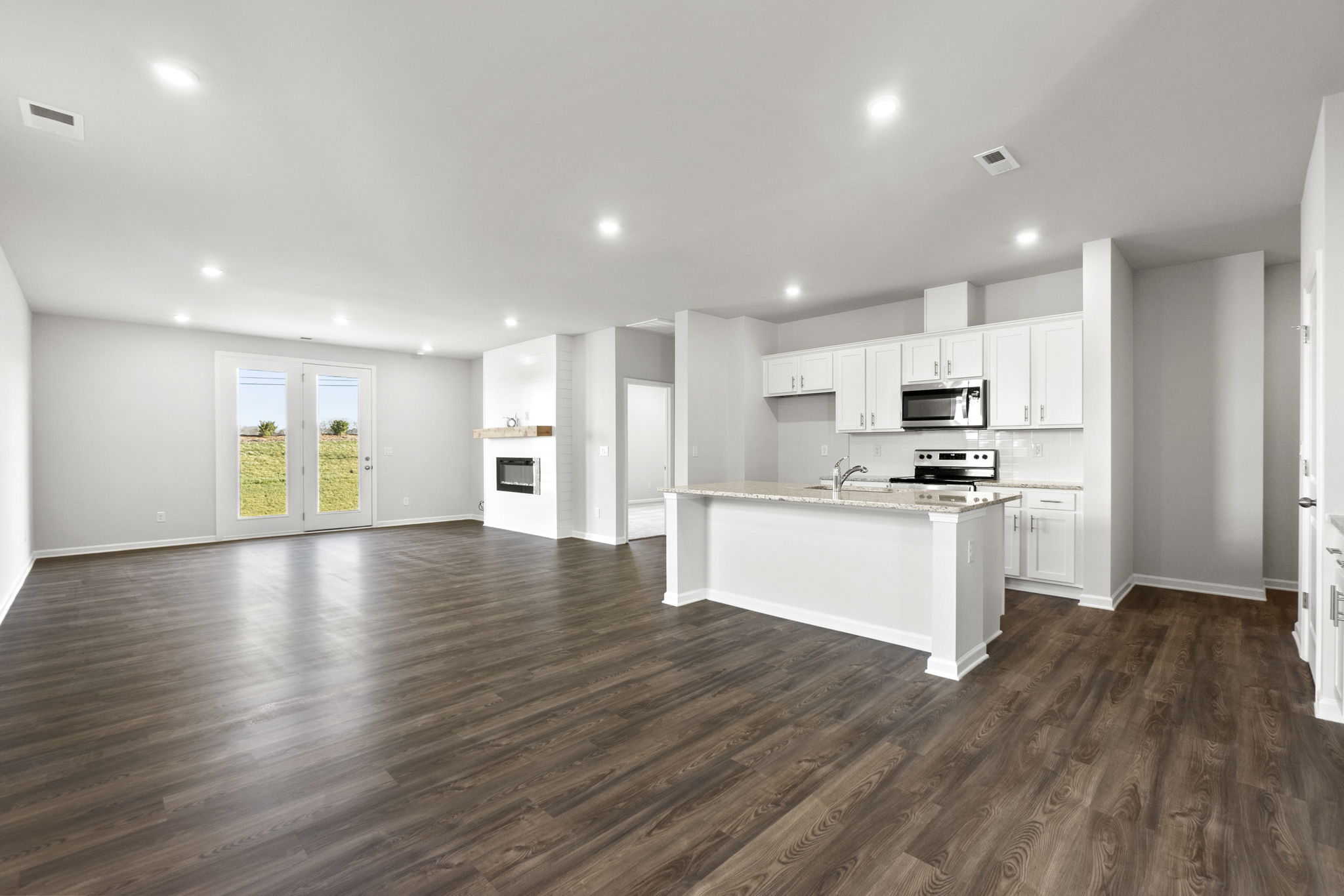 A large kitchen with white cabinets.